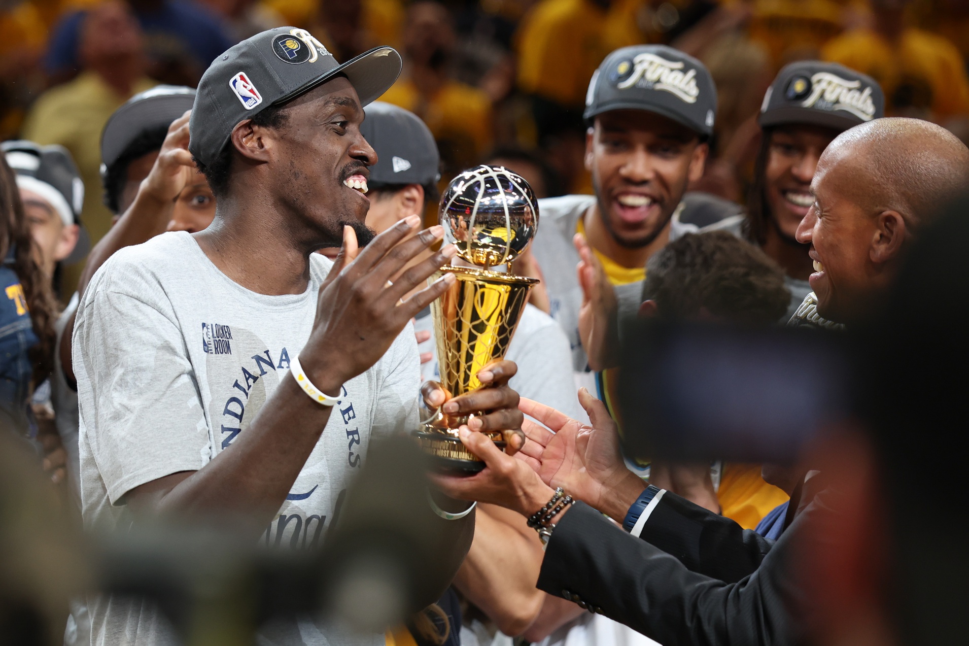 Indiana Pacers forward Pascal Siakam (43) receives the Larry Bird MVP Trophy from Reggie Miller after game six of the eastern conference finals against the New York Knicks for the 2025 NBA Playoffs at Gainbridge Fieldhouse.