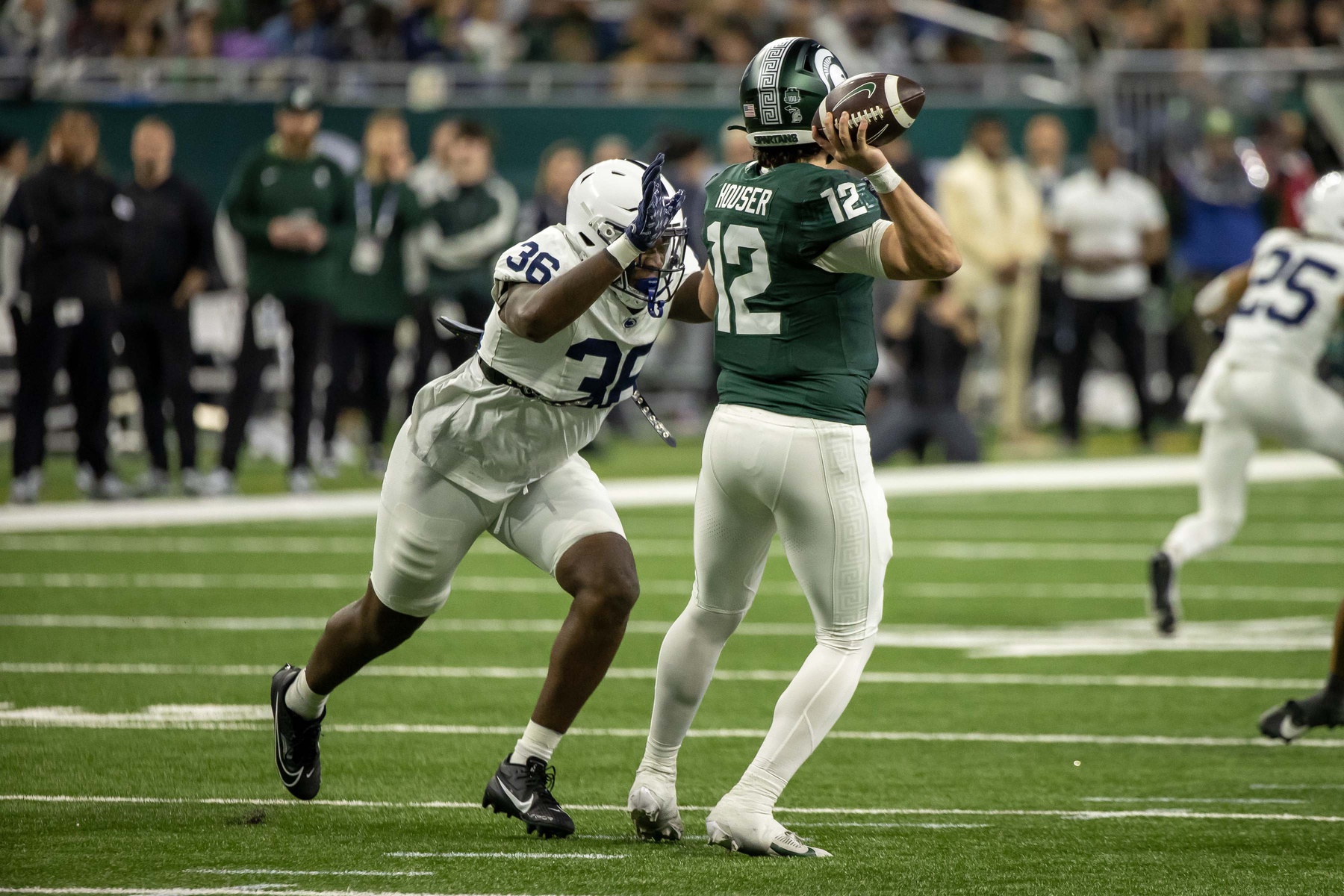 Michigan State Spartans quarterback Katin Houser (12) passes the ball while pressured by Penn State Nittany Lions defensive end Zuriah Fisher (36) during the first half at Ford Field.