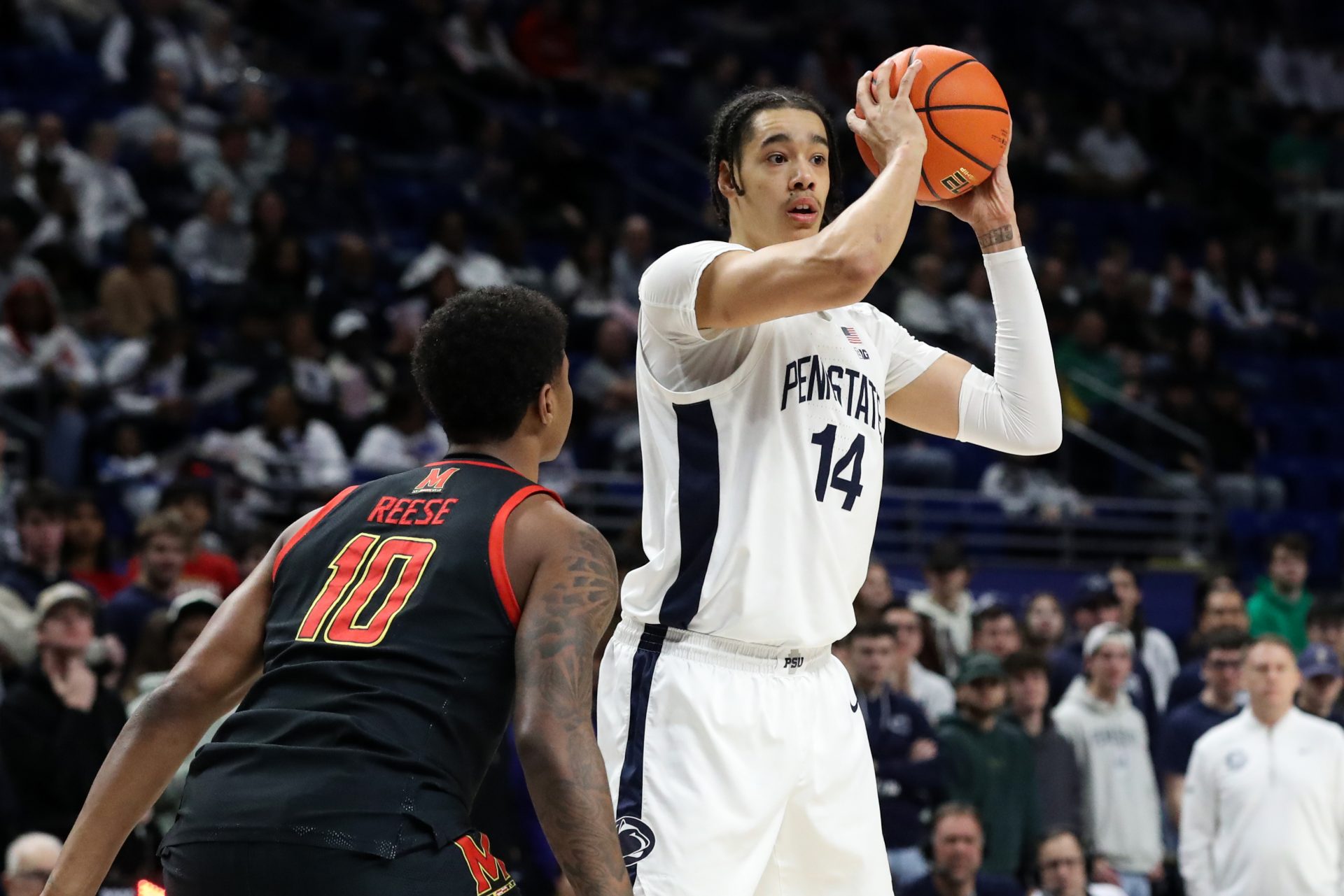 Penn State Nittany Lions forward Yanic Konan Niederhauser (14) looks to pass the ball as Maryland Terrapins forward Julian Reese (10) defends during the first half at Bryce Jordan Center.