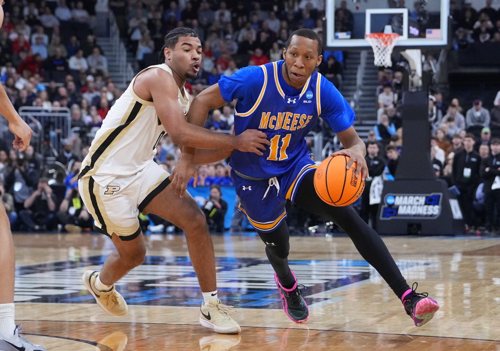 McNeese State Cowboys guard Quadir Copeland (11) drives against Purdue Boilermakers guard C.J. Cox (0) during the first half of a second round men’s NCAA Tournament game at Amica Mutual Pavilion.