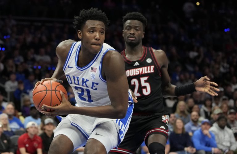 Duke Blue Devils center Patrick Ngongba II (21) grabs a rebound against Louisville Cardinals forward Aboubacar Traore (25) in the first half of the 2025 ACC Conference Championship game at Spectrum Center.