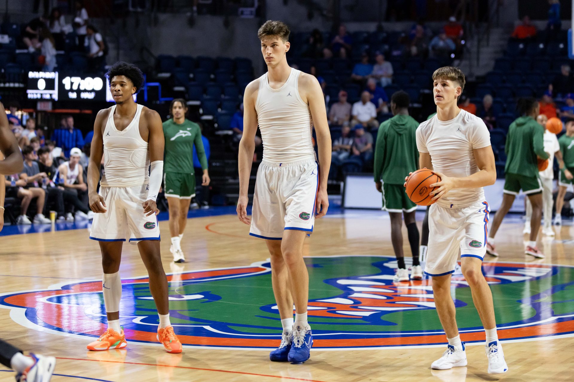 Florida Gators center Olivier Rioux (32) stands between forward Sam Alexis (4) and forward Alex Condon (21) before the game against the Jacksonville Dolphins at Exactech Arena at the Stephen C. O'Connell Center.