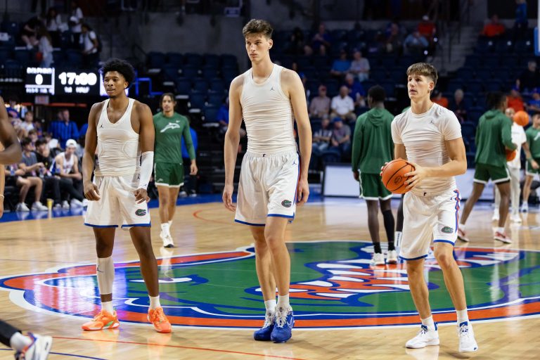 Florida Gators center Olivier Rioux (32) stands between forward Sam Alexis (4) and forward Alex Condon (21) before the game against the Jacksonville Dolphins at Exactech Arena at the Stephen C. O'Connell Center.