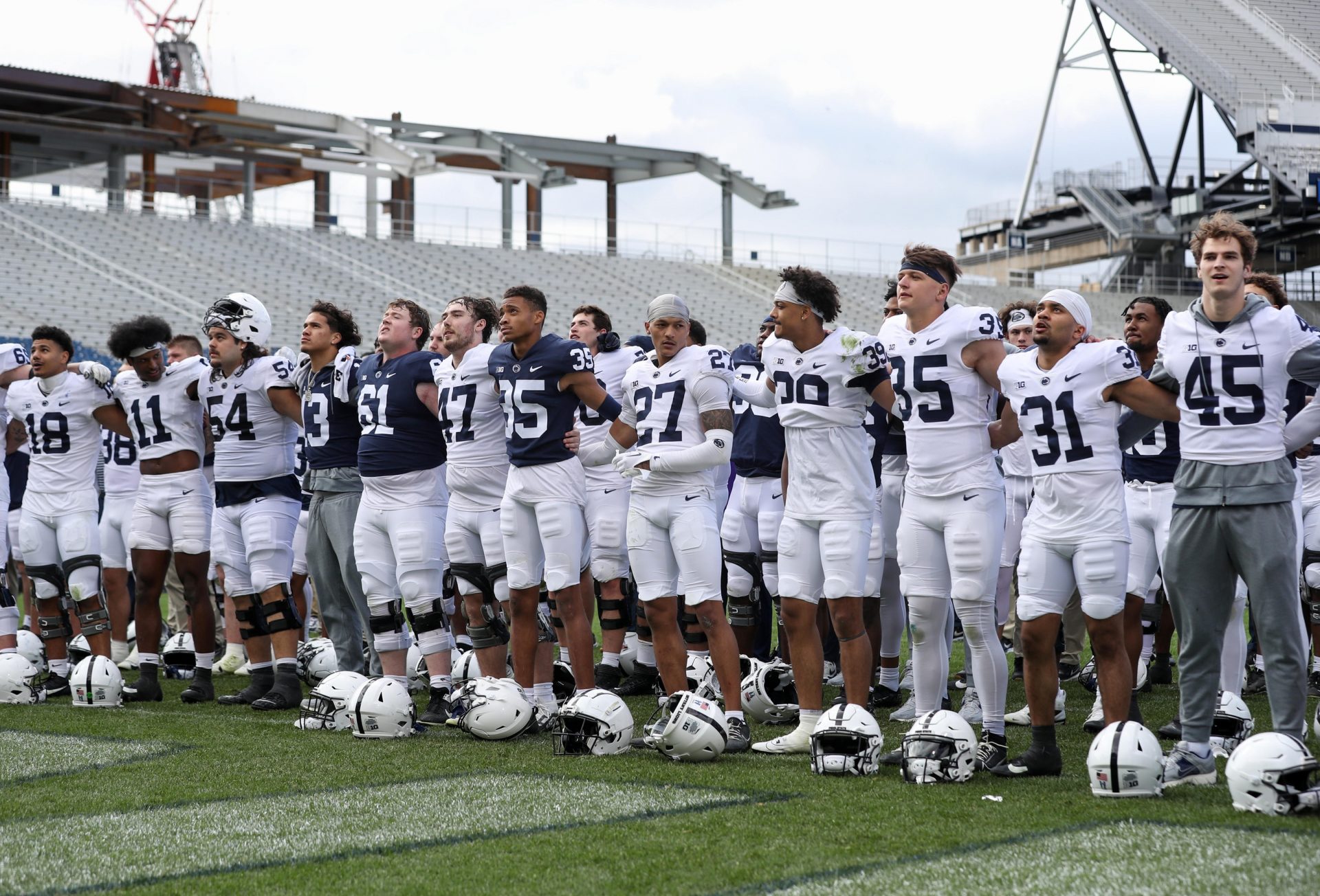 The Penn State Nittany Lion players sing their alma mater following the Blue White spring game at Beaver Stadium. The White team defeated the Blue team 10-8.