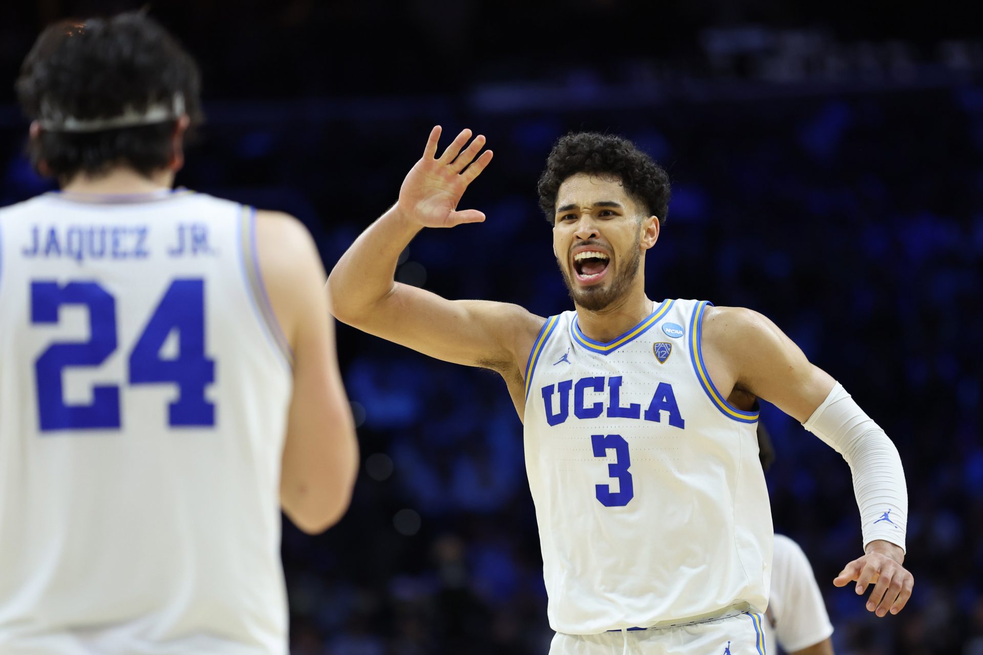 UCLA Bruins guard Johnny Juzang (3) and guard Jaime Jaquez Jr. (24) react in the second half against the North Carolina Tar Heels in the semifinals of the East regional of the men's college basketball NCAA Tournament at Wells Fargo Center.