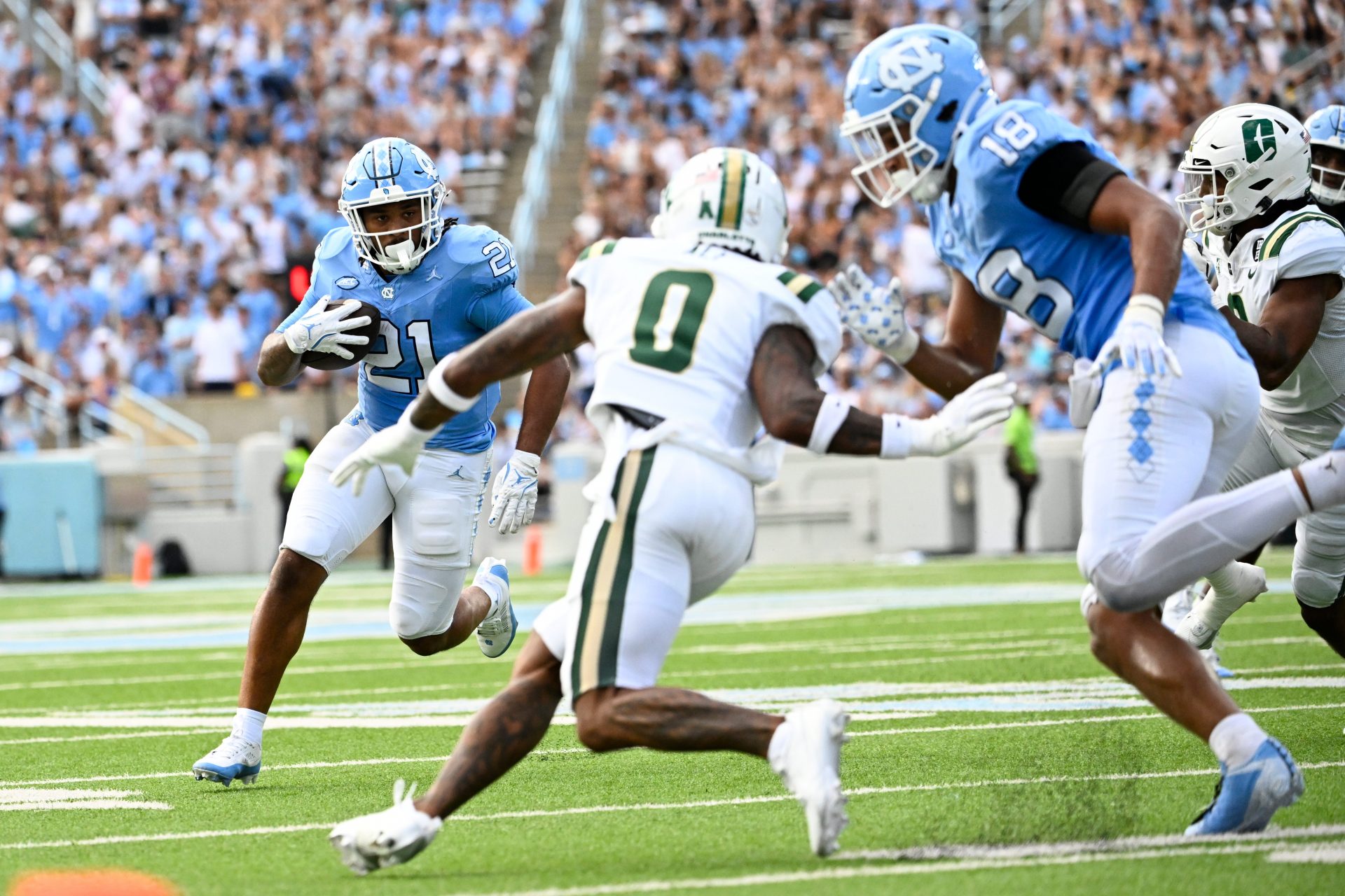 North Carolina Tar Heels running back Davion Gause (21) with the ball as Charlotte 49ers defensive back Al-Ma'hi Ali (0) defends in the second quarter at Kenan Memorial Stadium.