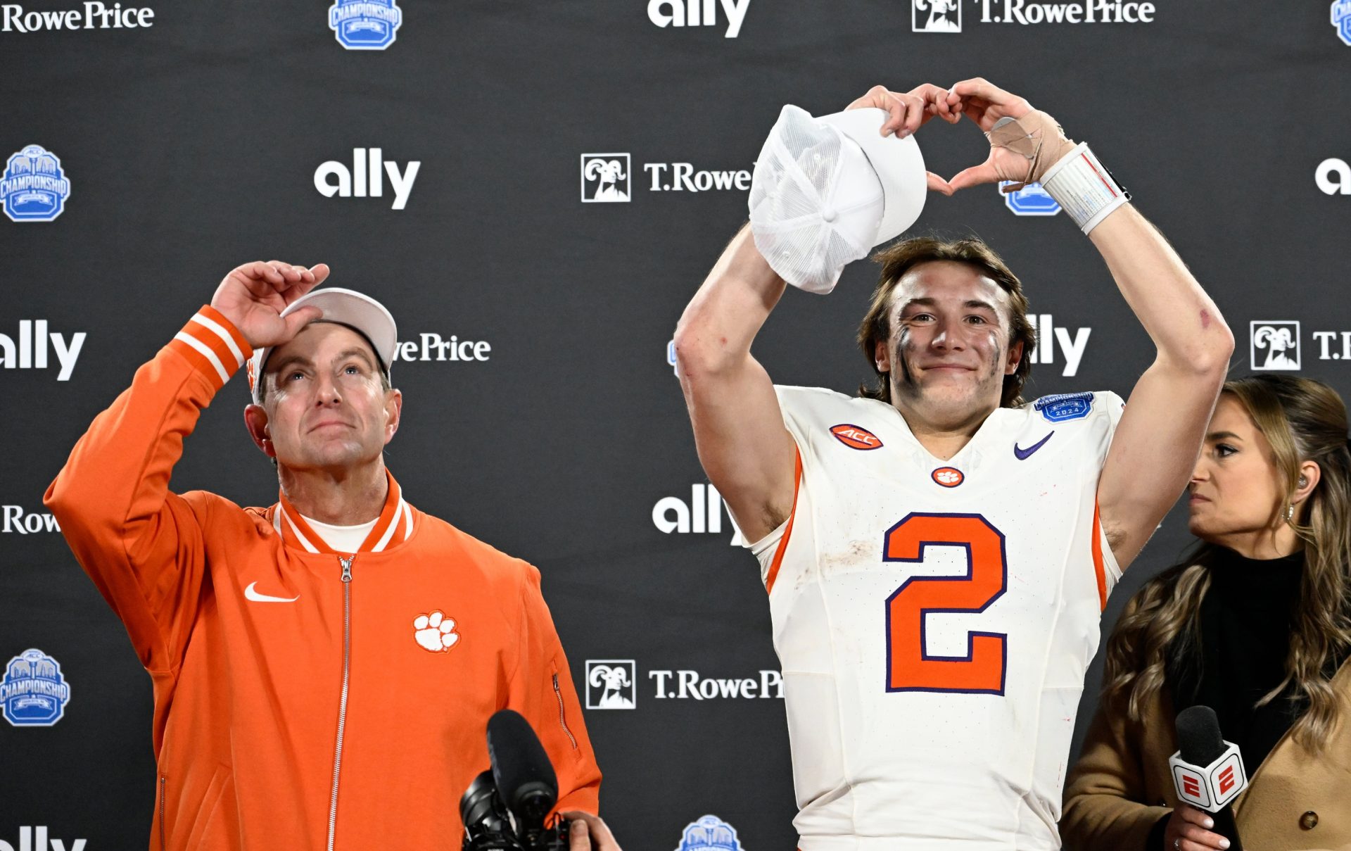 Clemson Tigers head coach Dabo Swinney, and quarterback Cade Klubnik (2) celebrate after winning the 2024 ACC Championship game against the Southern Methodist Mustangs at Bank of America Stadium.