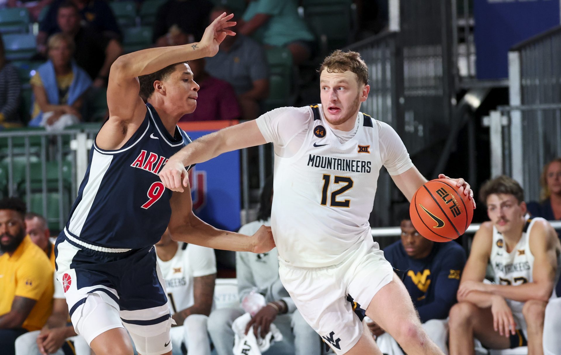 West Virginia Mountaineers guard Tucker DeVries (12) drives to the basket as Arizona Wildcats forward Carter Bryant (9) defends during the second half at Imperial Arena at the Atlantis resort.