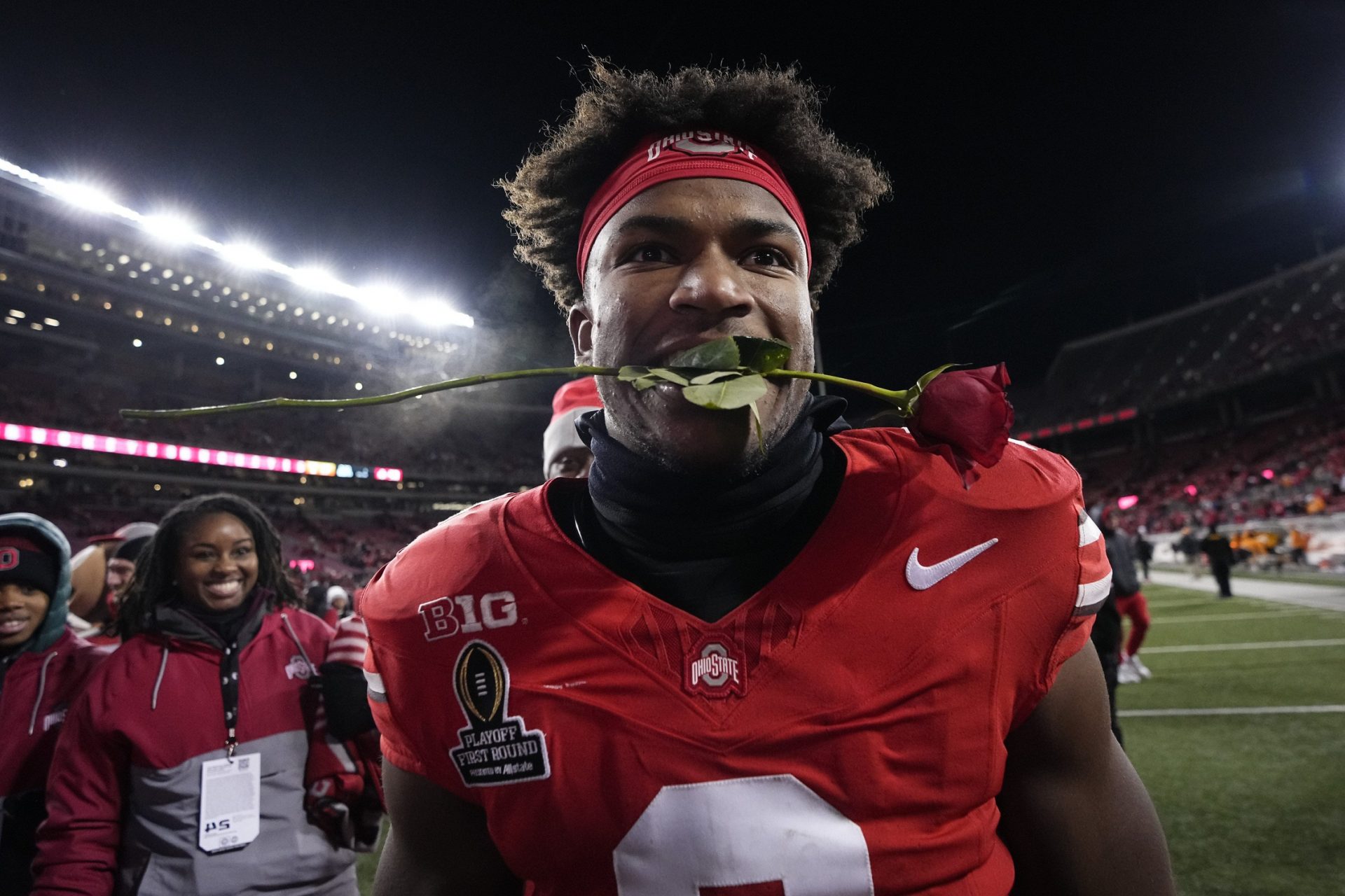 Ohio State Buckeyes safety Caleb Downs leaves the field with a rose in his mouth following the 42-17 win over the Tennessee Volunteers in the College Football Playoff first round game at Ohio Stadium in Columbus on Dec. 21, 2024. Ohio State will face Oregon in the Rose Bowl.