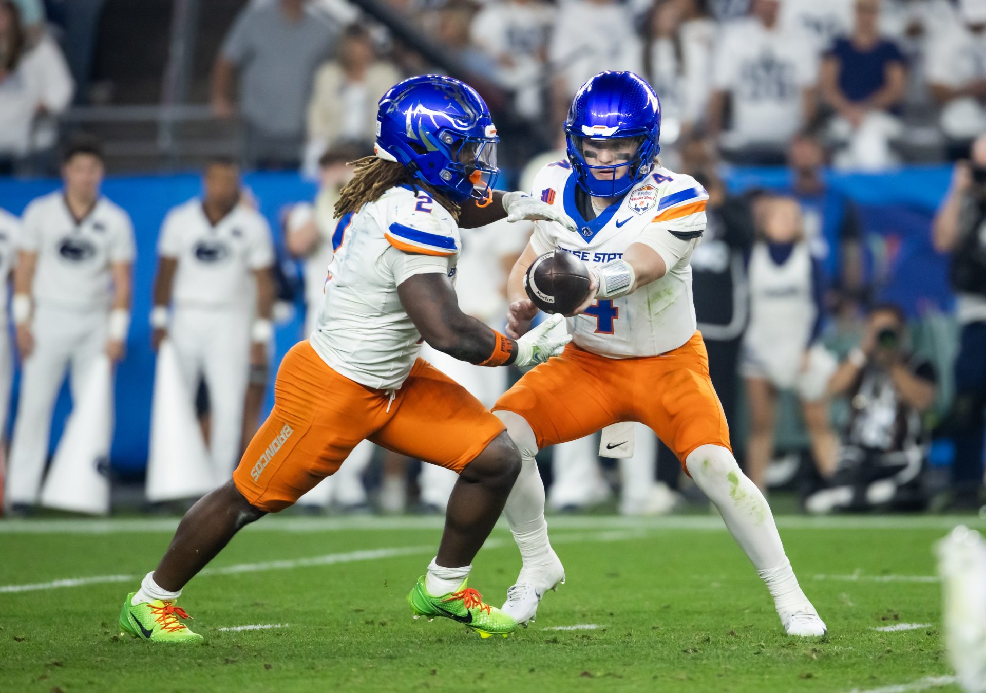 Boise State Broncos quarterback Maddux Madsen (4) hands off the ball to running back Ashton Jeanty (2) against the Penn State Nittany Lions during the Fiesta Bowl at State Farm Stadium.