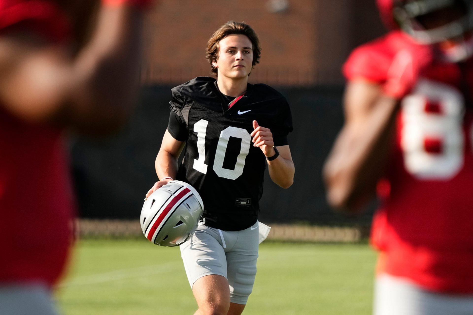 Ohio State Buckeyes quarterback Julian Sayin (10) runs between drills during football camp at the Woody Hayes Athletic Complex.