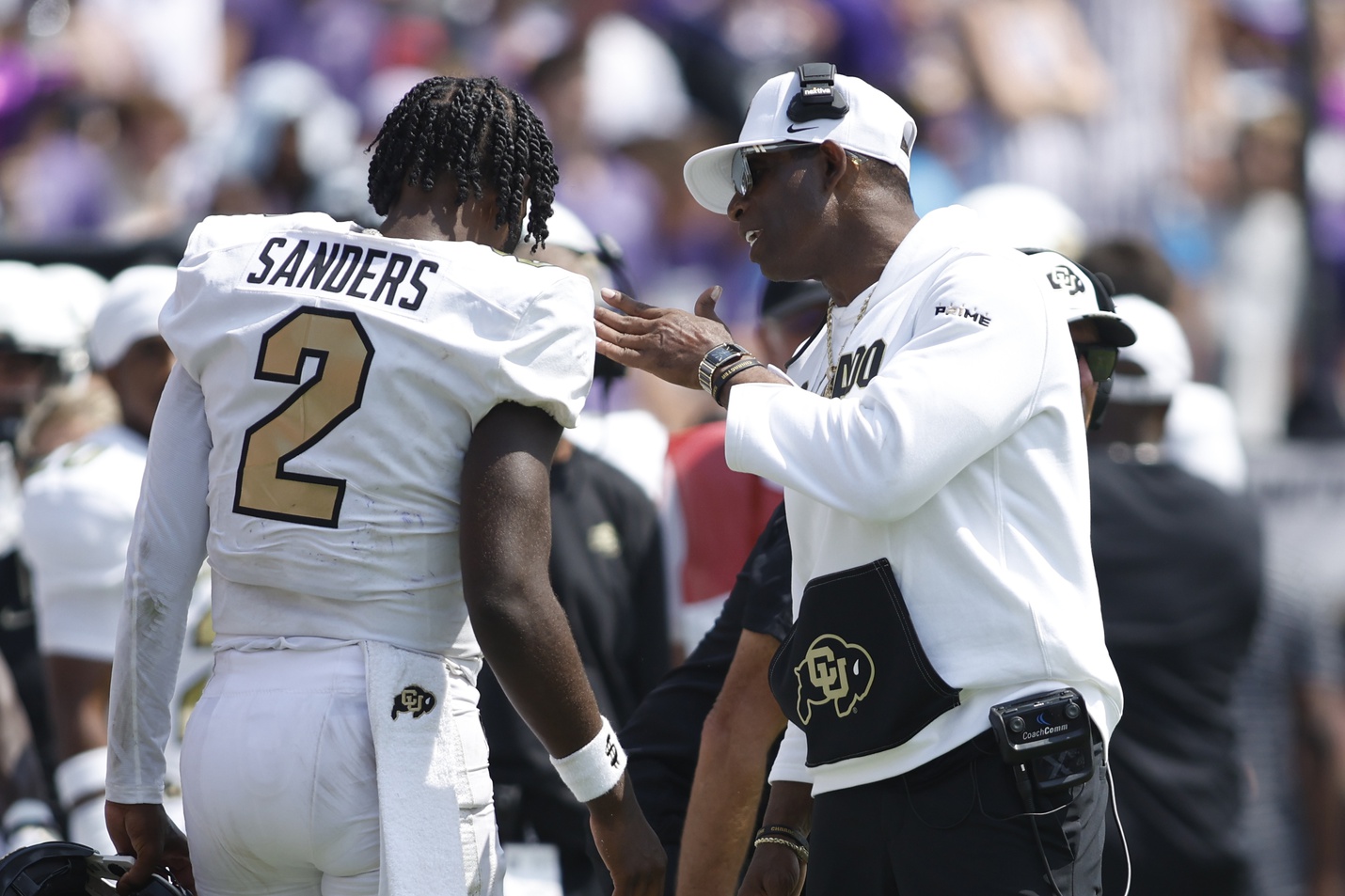 Colorado Buffaloes head coach Deion Sanders talks to quarterback Shedeur Sanders (2) after a touchdown in the fourth quarter against the TCU Horned Frogs at Amon G. Carter Stadium.