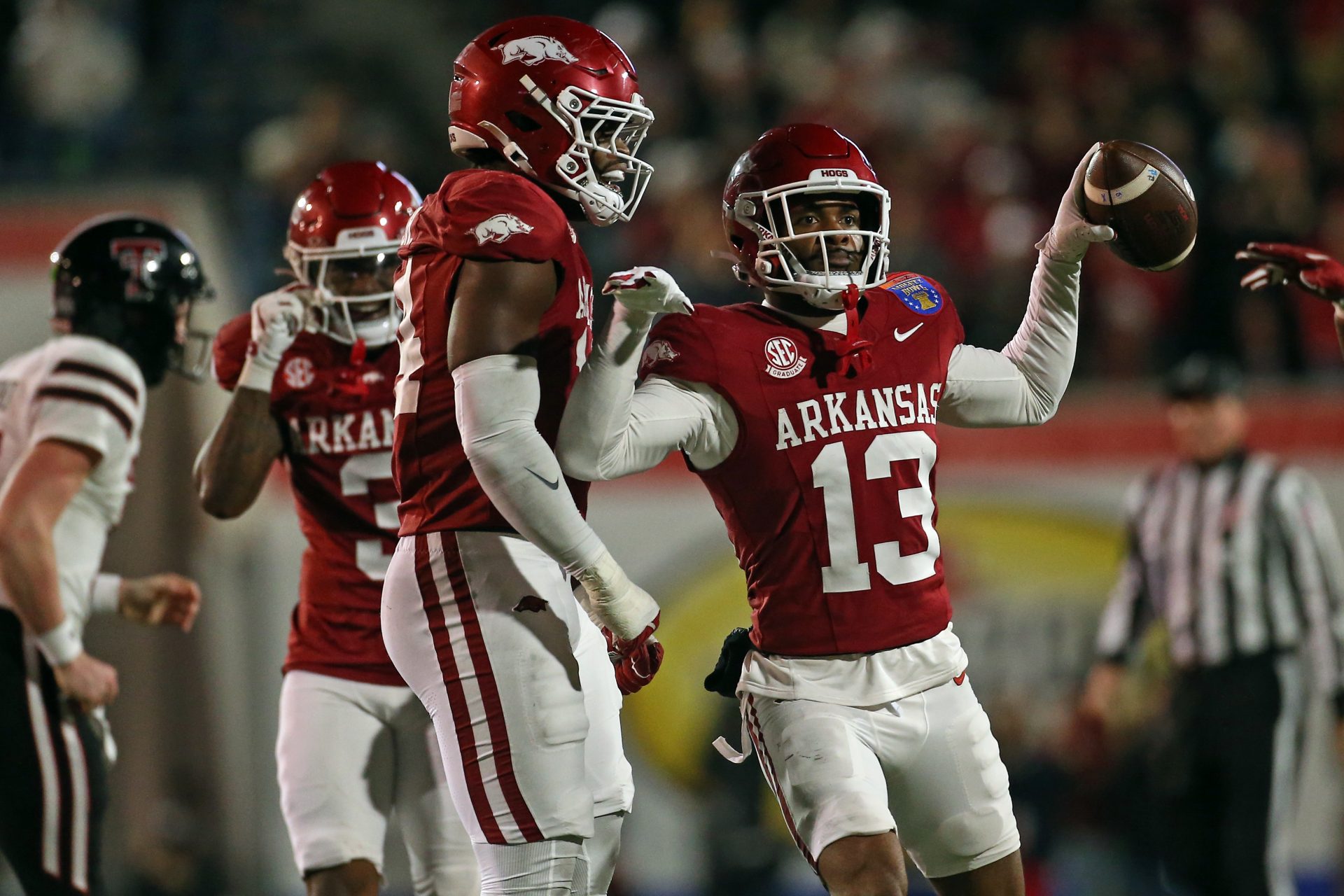 Arkansas Razorbacks linebacker Stephen Dix Jr. (14) reacts with defensive back Marquise Robinson (13) after an interception during the third quarter  against the Texas Tech Red Raiders at Simmons Bank Liberty Stadium.