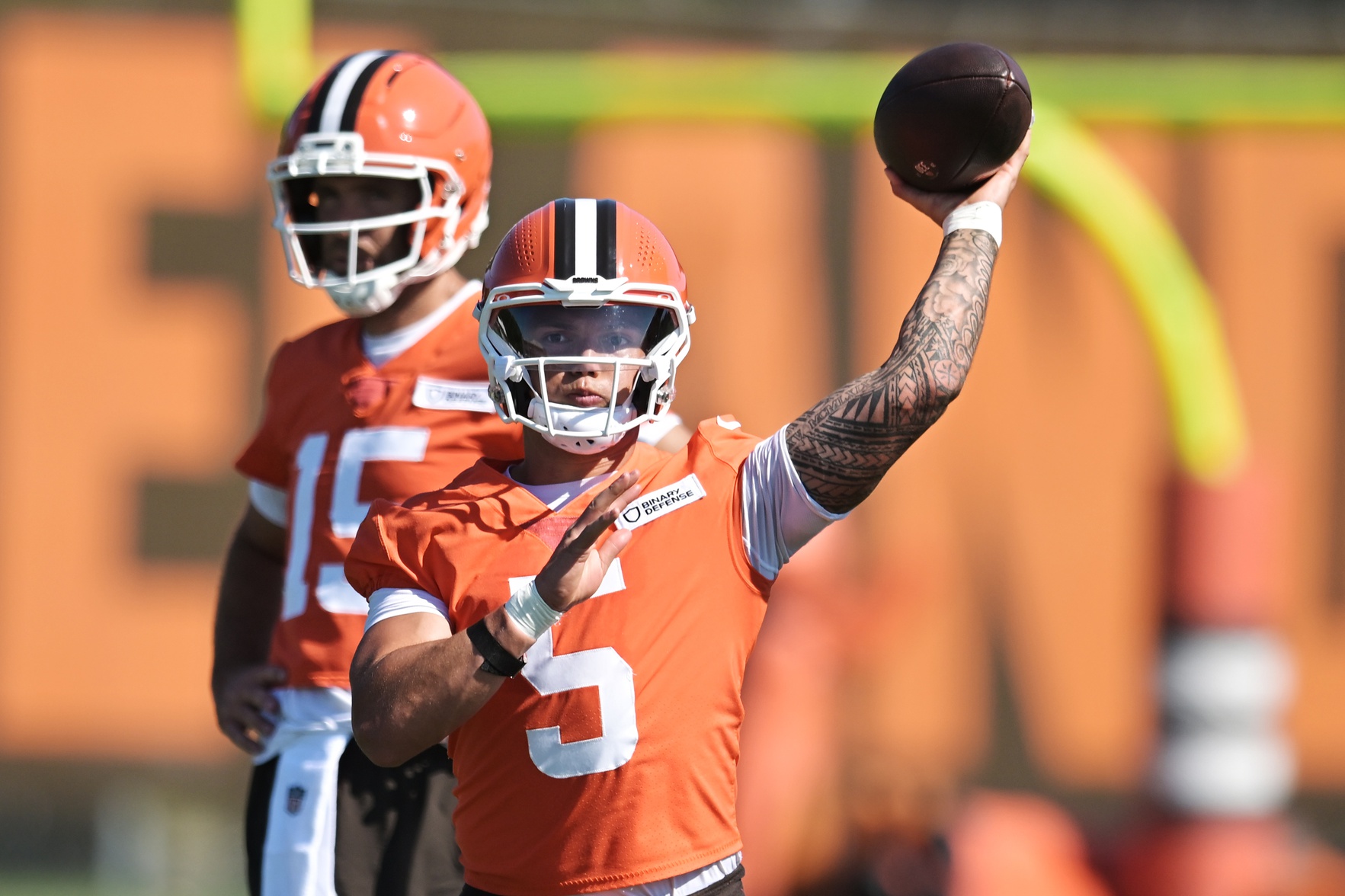 Cleveland Browns quarterback Dillon Gabriel (5) throws a pass as quarterback Joe Flacco (15) looks on during training camp at CrossCountry Mortgage Campus.