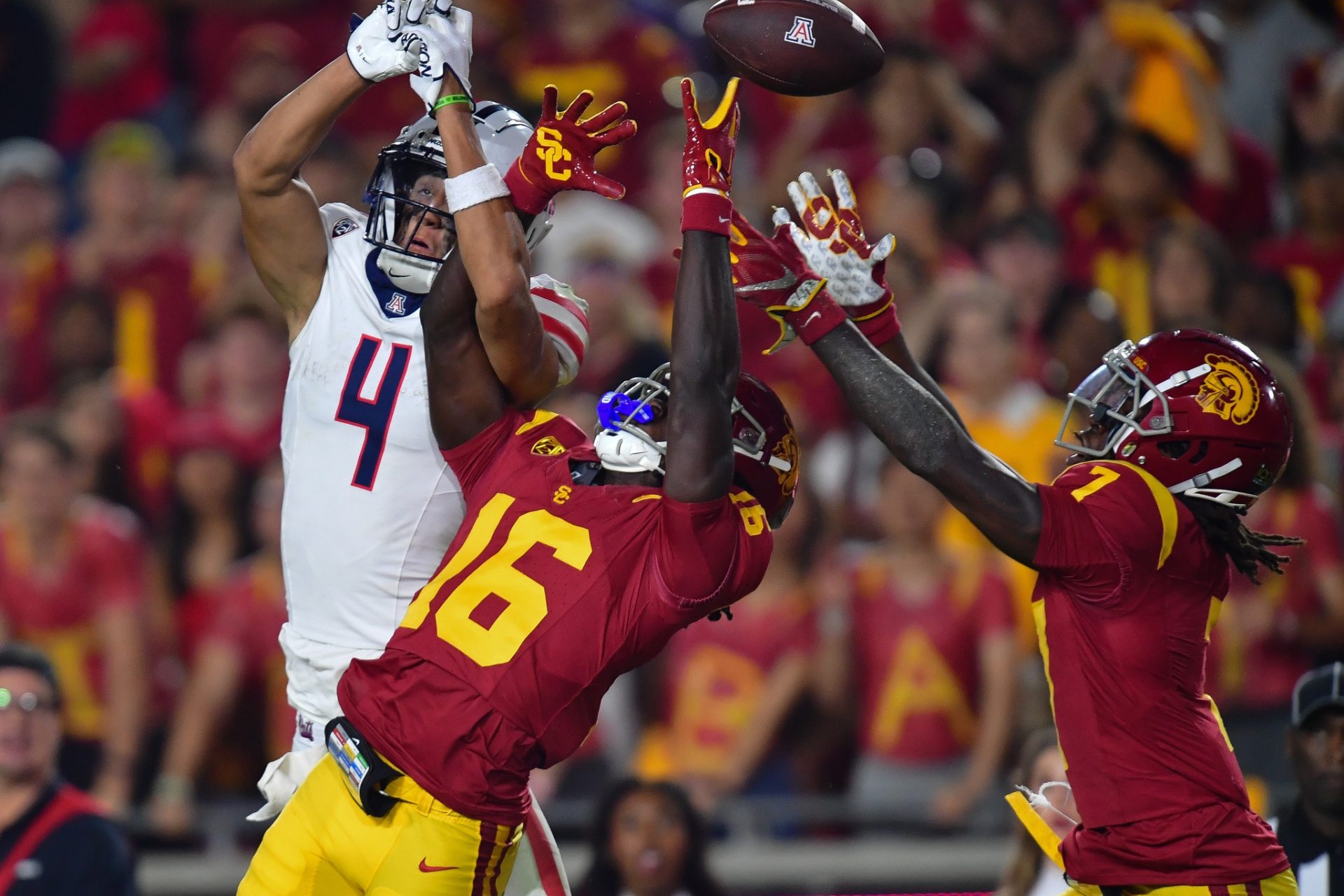 Southern California Trojans cornerback Prophet Brown (16) and safety Calen Bullock (7) break up a pass intended for Arizona Wildcats wide receiver Tetairoa McMillan (4) during the second half at Los Angeles Memorial Coliseum.