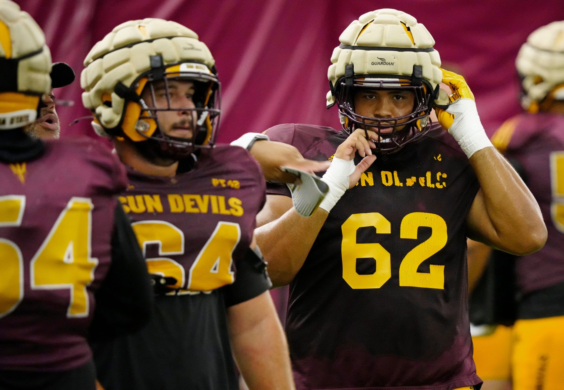 Arizona State offensive linemen Wade Helton (64) and Ben Coleman (62) run a drill during a practice inside the Verde Dickey Dome in Tempe on August 12, 2025.