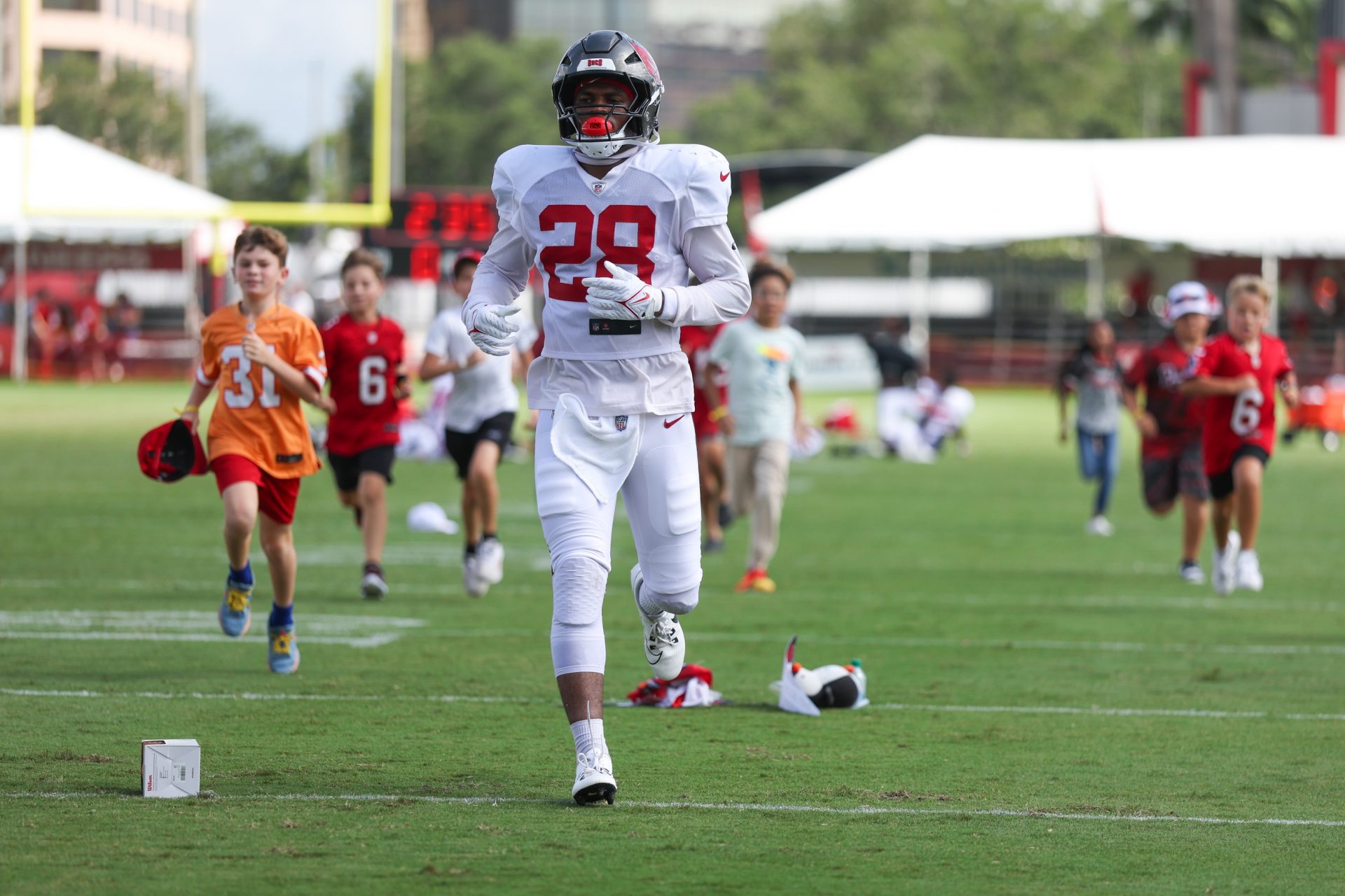 Tampa Bay Buccaneers safety Shilo Sanders (28) runs with fans after training camp at AdventHealth Training Center.