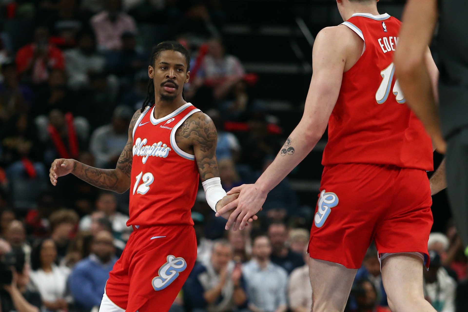 Memphis Grizzlies guard Ja Morant (12) reacts with center Zach Edey (14) during the second quarter against the Minnesota Timberwolves at FedExForum.