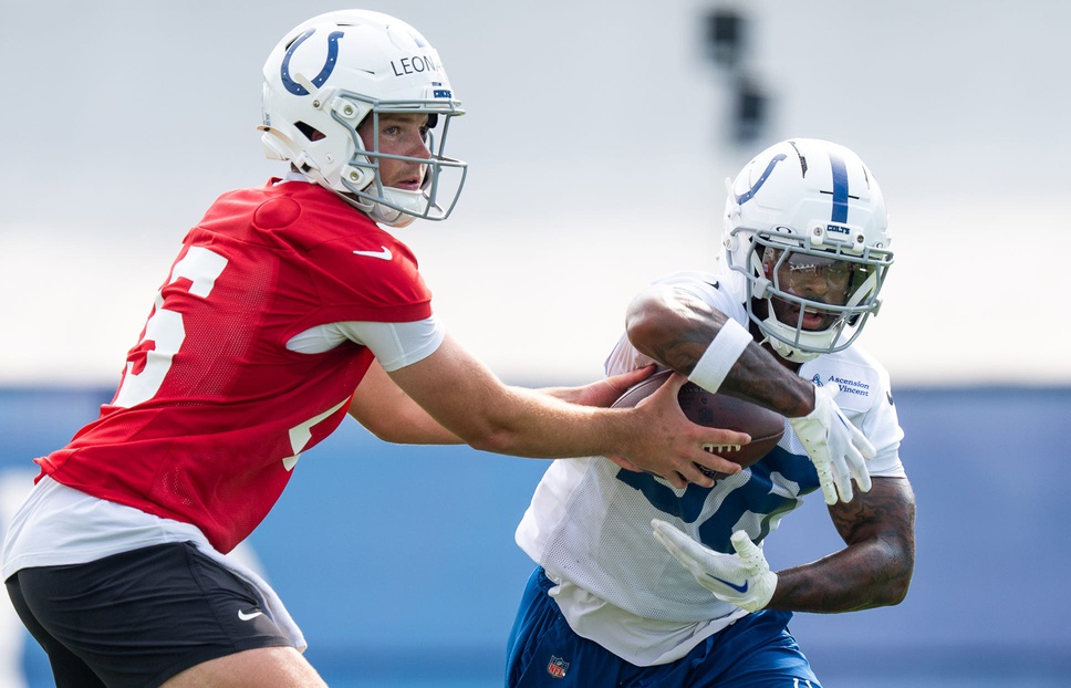 Indianapolis Colts quarterback Riley Leonard (15) hands off Friday, July 25, 2025, to running back Salvon Ahmed (36) during training camp held at Grand Park in Westfield.
