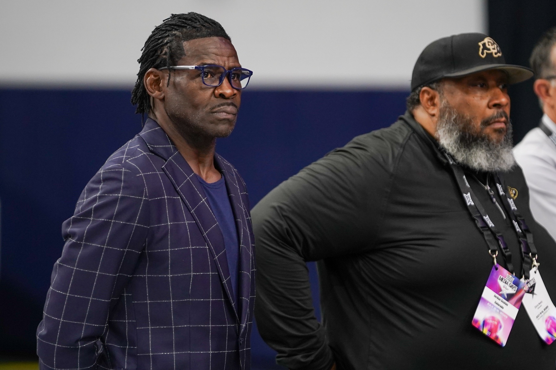 Former Dallas Cowboy and teammate of Colorado head coach Deion Sanders, Michael Irvin looks on as Sanders speaks with the media during 2025 Big 12 Football Media Days at The Star.