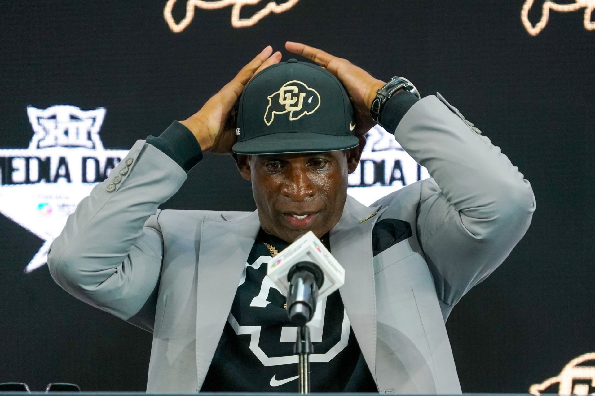 Colorado head coach Deion Sanders fixes his cap prior to speaking with the media during 2025 Big 12 Football Media Days at The Star.