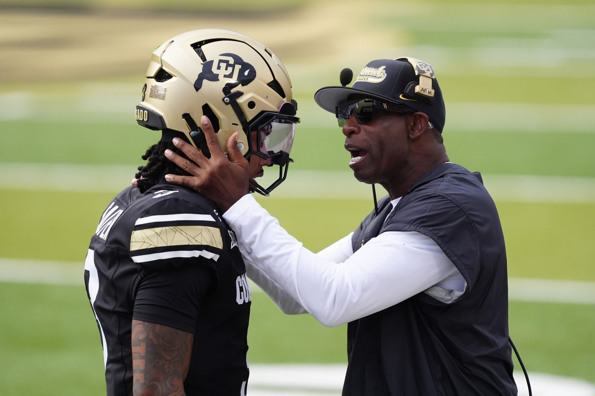 Colorado Buffaloes head coach Deion Sanders congratulates Colorado Buffaloes quarterback Kaidon Salter (3) following a touchdown pass in the first quarter against the Georgia Tech Yellow Jackets at Folsom Field.