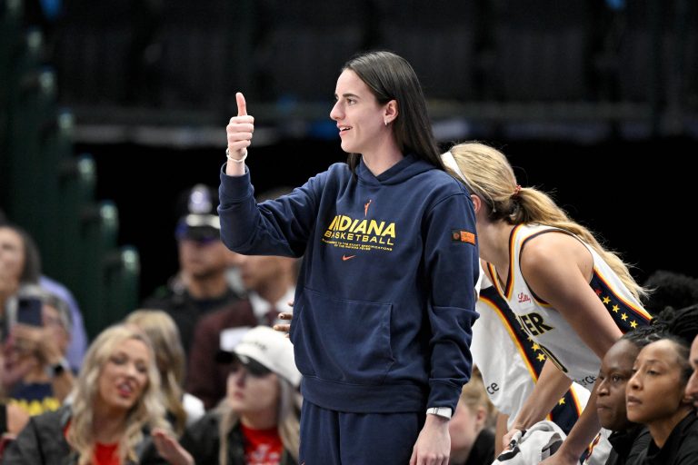 Indiana Fever guard Caitlin Clark (22) gives a thumbs up during the first half against the Dallas Wings at the American Airlines Center.