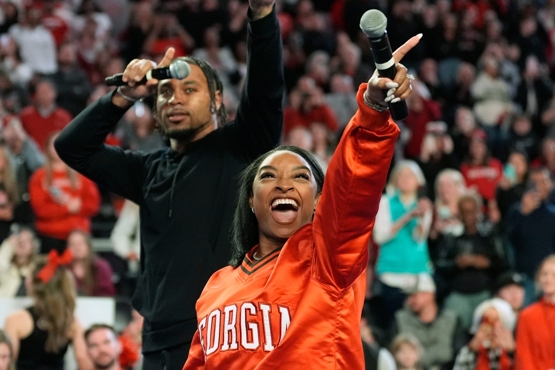 Simone Biles calls the Dawg with her husband Jonathan Owens during a NCAA gymnastics meet against Boise State in Athens, Ga., on Friday, Jan. 17, 2024. Georgia won 196.825 to 193.600.