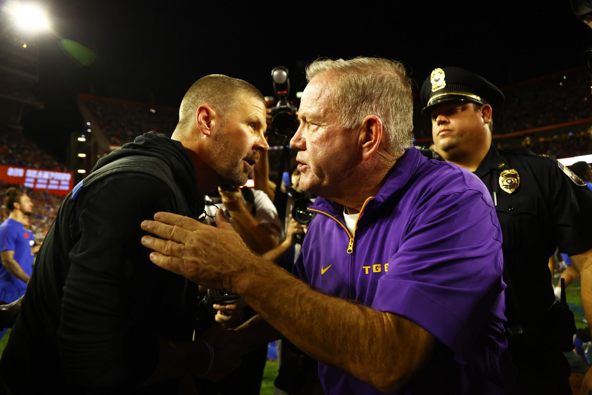 LSU Tigers head coach Brian Kelly and Florida Gators head coach Billy Napier greet after the game at Ben Hill Griffin Stadium.