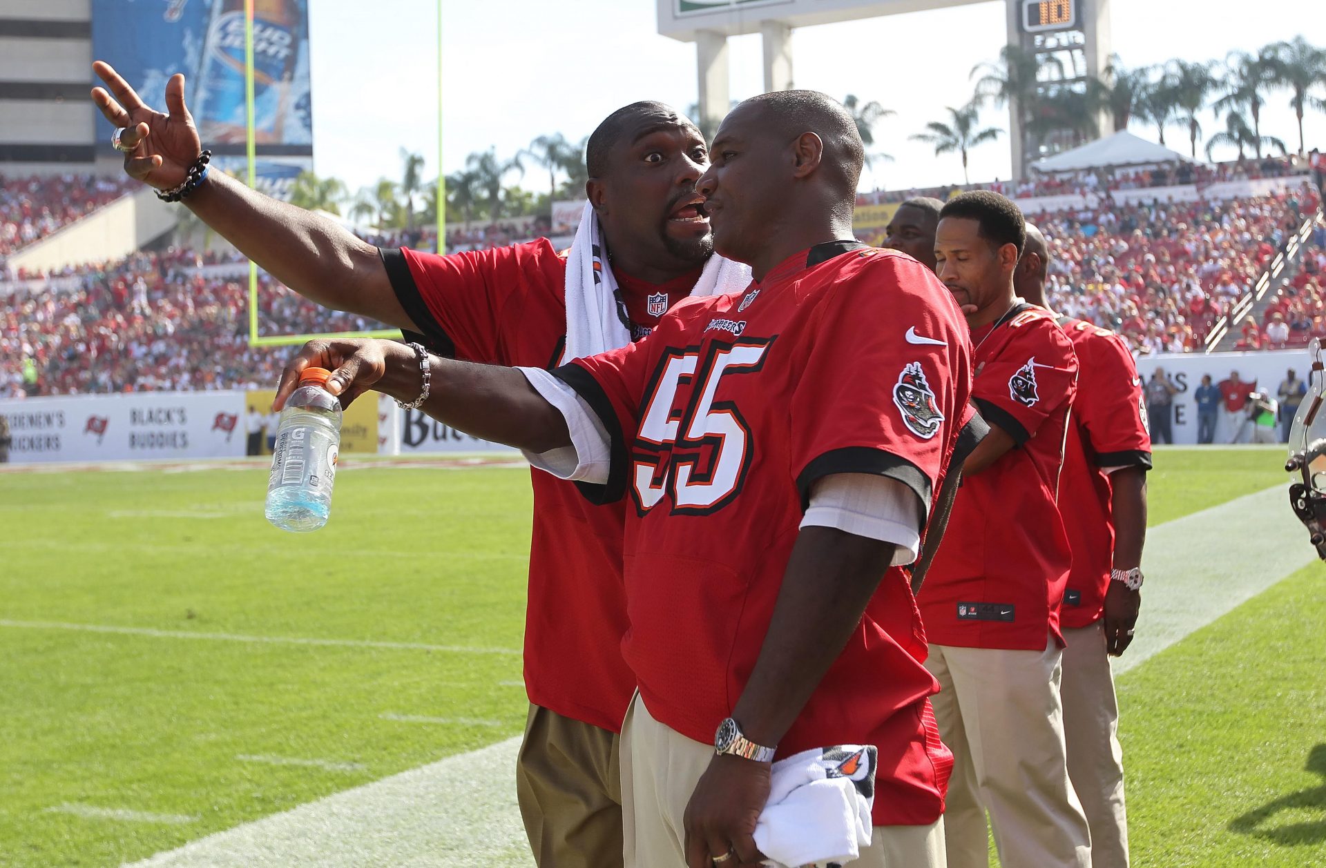 Tampa Bay Buccaneers former player Warren Sapp (left) and former player Derrick Brooks talk on the sidelines during the first half against the Philadelphia Eagles at Raymond James Stadium.Former players of the 2002 super bowl championship team came back to celebrate their 10th anniversary.