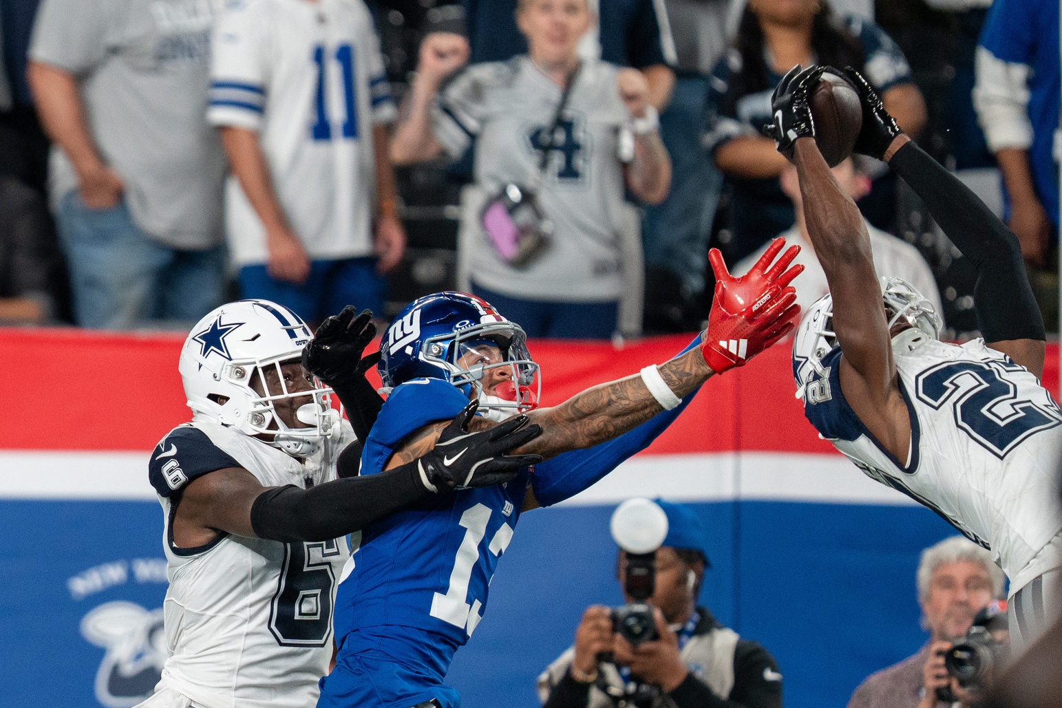 Dallas Cowboys cornerback Amani Oruwariye (27) intercepts a pass intended for New York Giants wide receiver Wan'Dale Robinson (17) at MetLife Stadium.