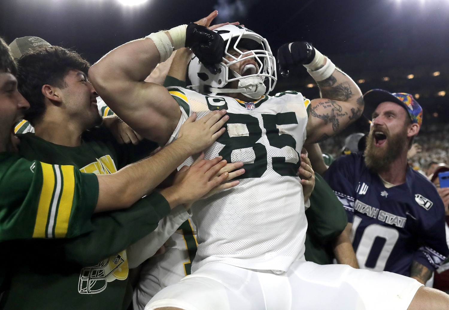 Green Bay Packers tight end Tucker Kraft (85) celebrates a touchdown with fans against the Washington Commanders at Lambeau Field.