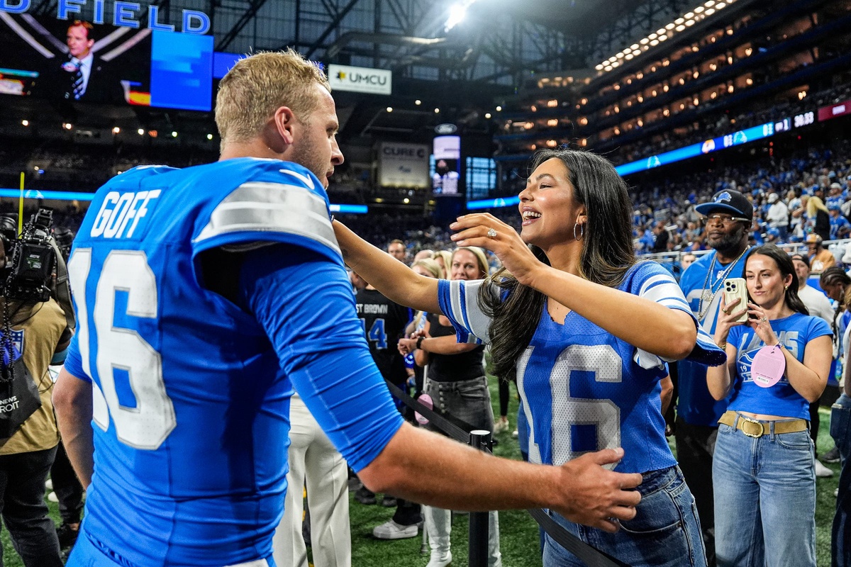 Detroit Lions quarterback Jared Goff hugs his wife Christen Harper during warmups before the season opener against the Los Angeles Rams at Ford Field in Detroit on Sunday, Sept. 8, 2024. The two were married in June 2024.