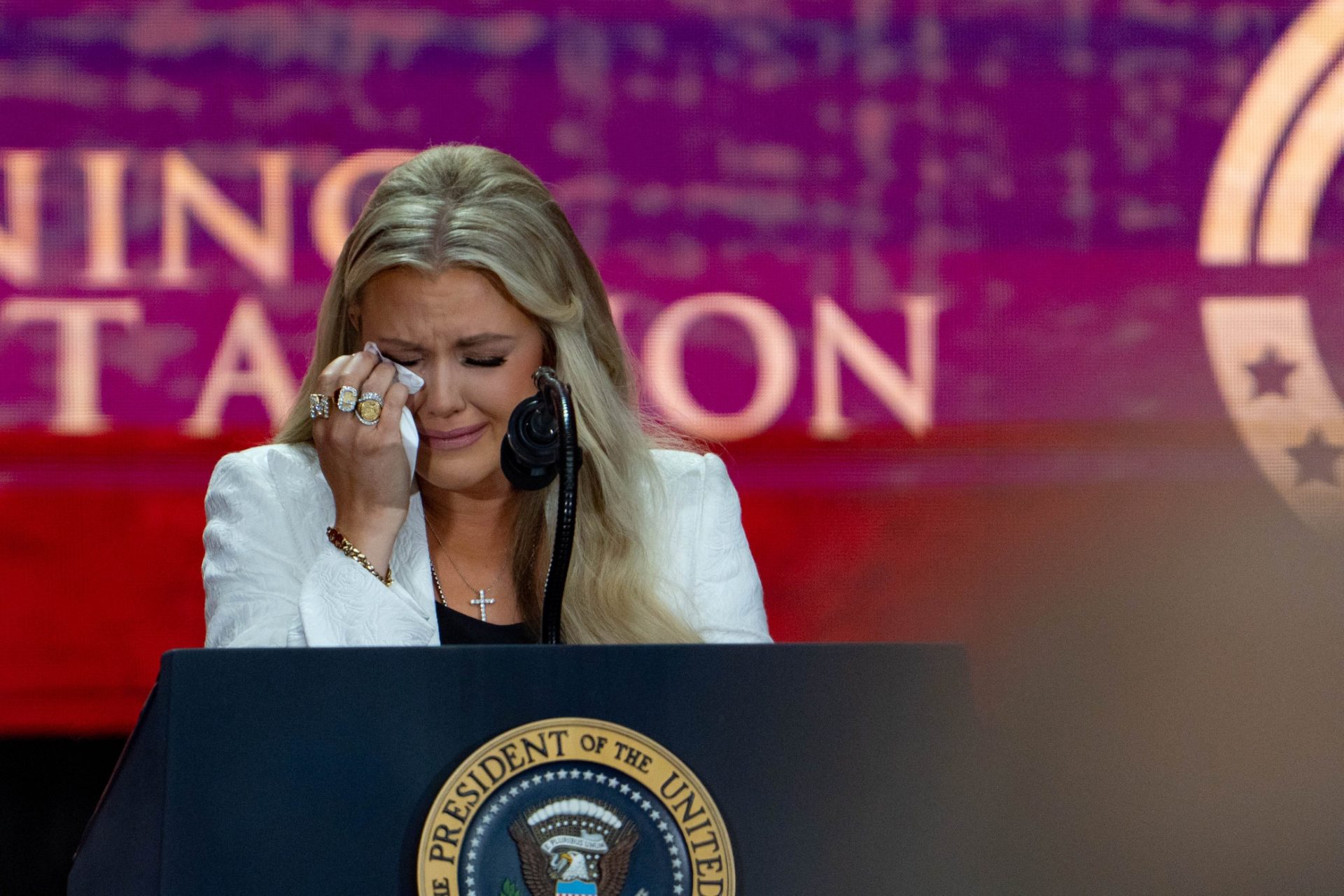 Erika Kirk wipes her tears as she speaks during a memorial service honoring Charlie Kirk at State Farm Stadium in Glendale on Sept. 21, 2025.
