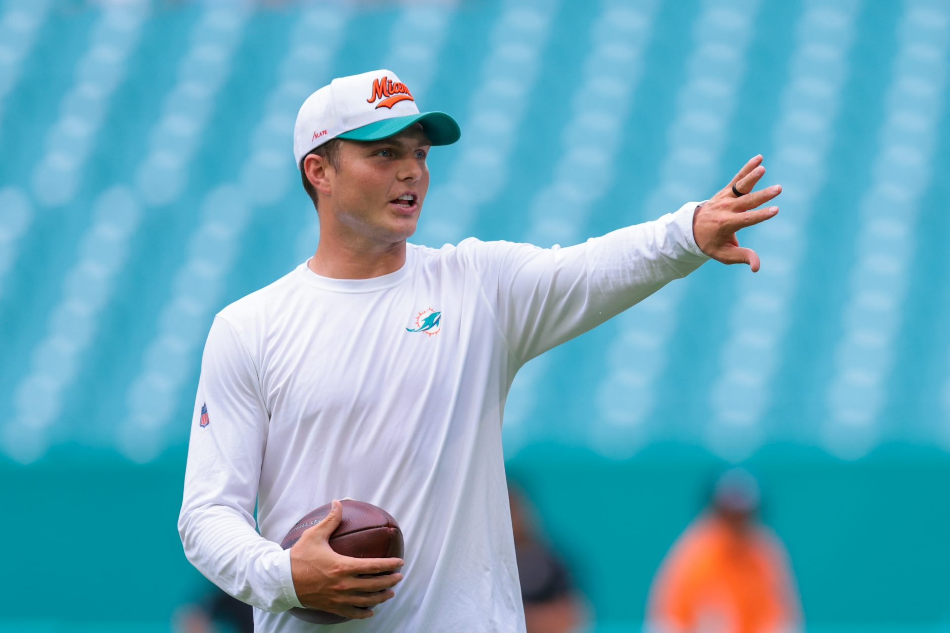 Miami Dolphins quarterback Zach Wilson (0) talks to a teammate before the game against the Jacksonville Jaguars at Hard Rock Stadium.