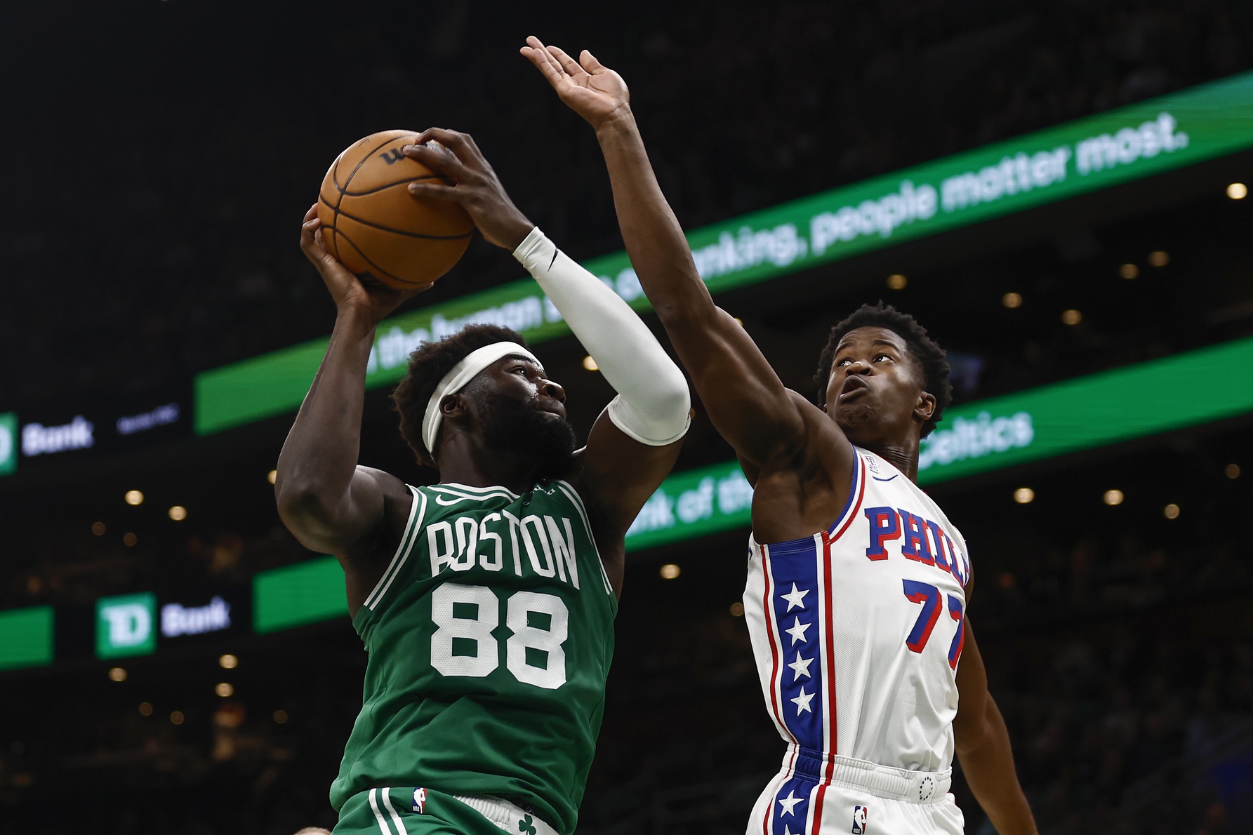 Boston Celtics center Neemias Queta (88) grabs a rebound next to Philadelphia 76ers guard VJ Edgecombe (77) during the first quarter at TD Garden.