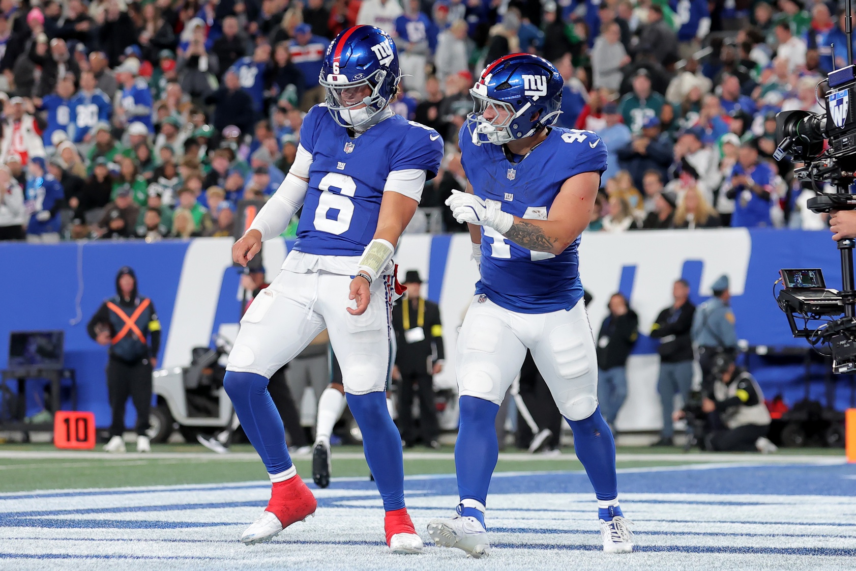 New York Giants quarterback Jaxson Dart (6) and running back Cam Skattebo (44) celebrate Skattebo's touchdown against the Philadelphia Eagles during the second quarter at MetLife Stadium.