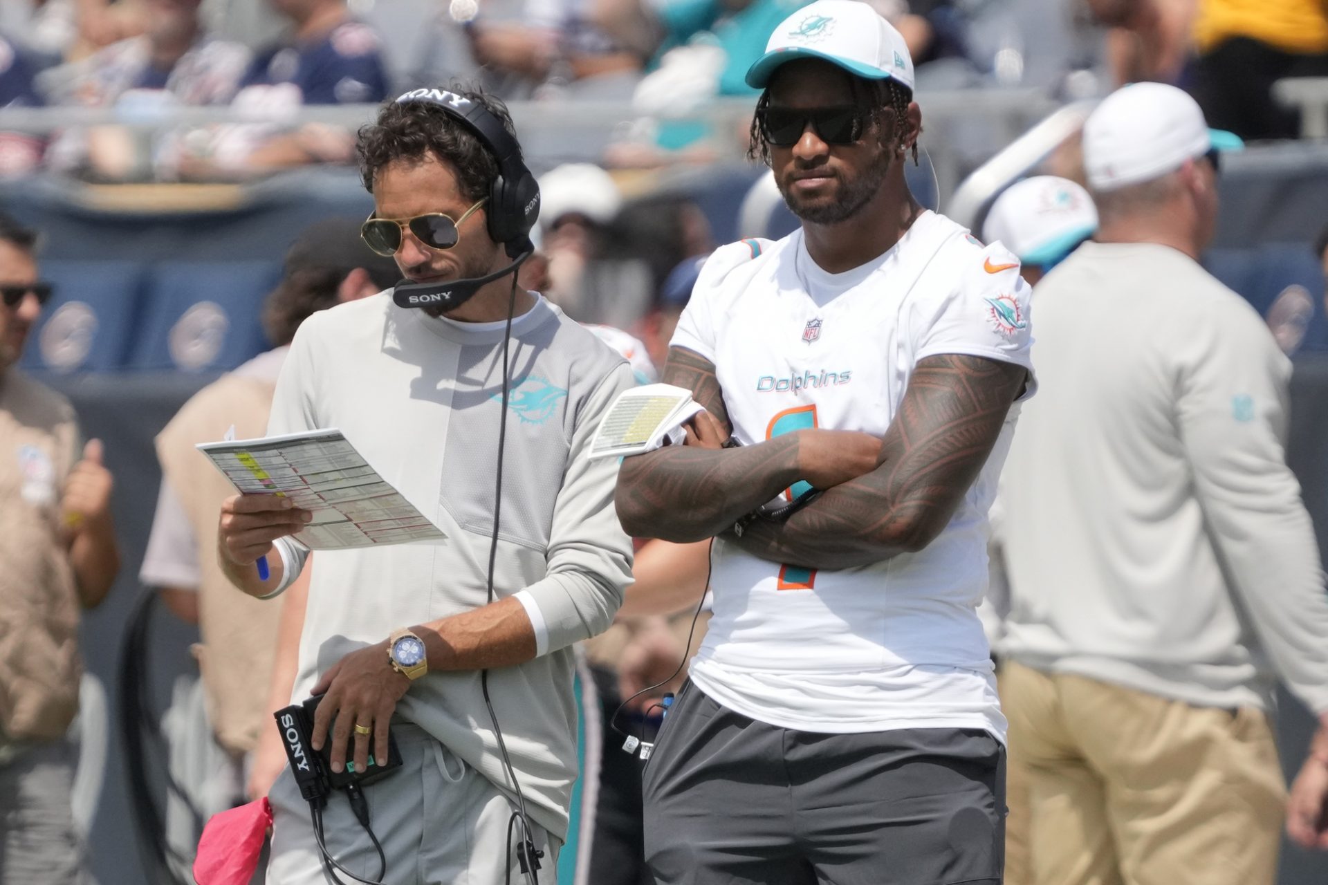 Miami Dolphins head coach Mike McDaniels with quarterback Tua Tagovailoa (1) on thee sidelines during the second half of a game against the Chicago Bears at Soldier Field.