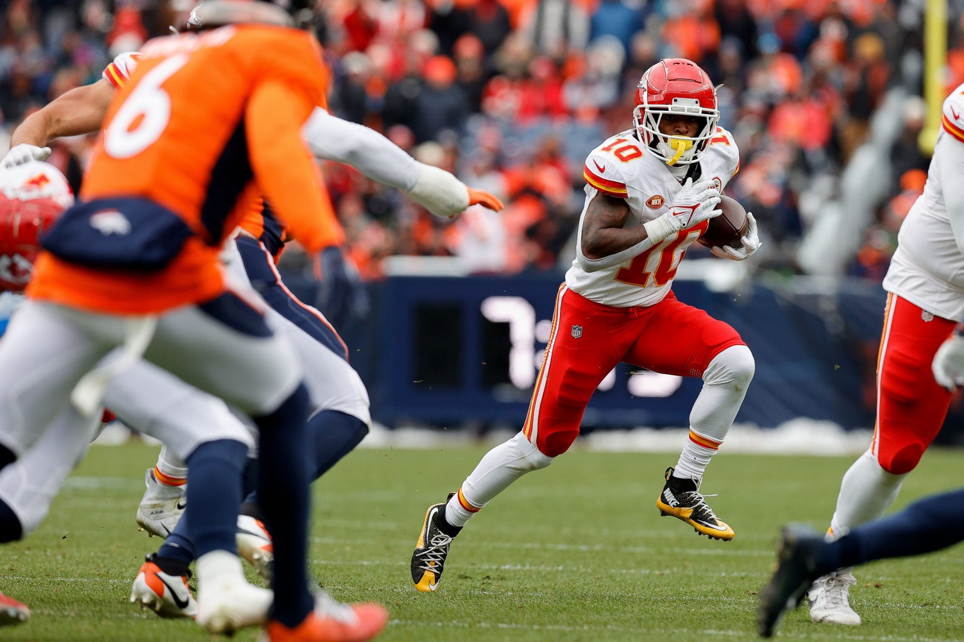Kansas City Chiefs running back Isiah Pacheco (10) runs the ball as Denver Broncos safety P.J. Locke (6) defends in the second quarter at Empower Field at Mile High.
