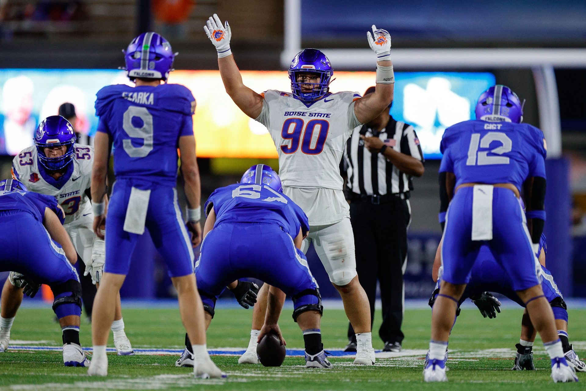 Boise State Broncos defensive lineman Braxton Fely (90) motions at the line of scrimmage against Air Force Falcons guard Costen Cooley (67) and quarterback Liam Szarka (9) and fullback Terrence Gist (12) in the fourth quarter at Falcon Stadium.