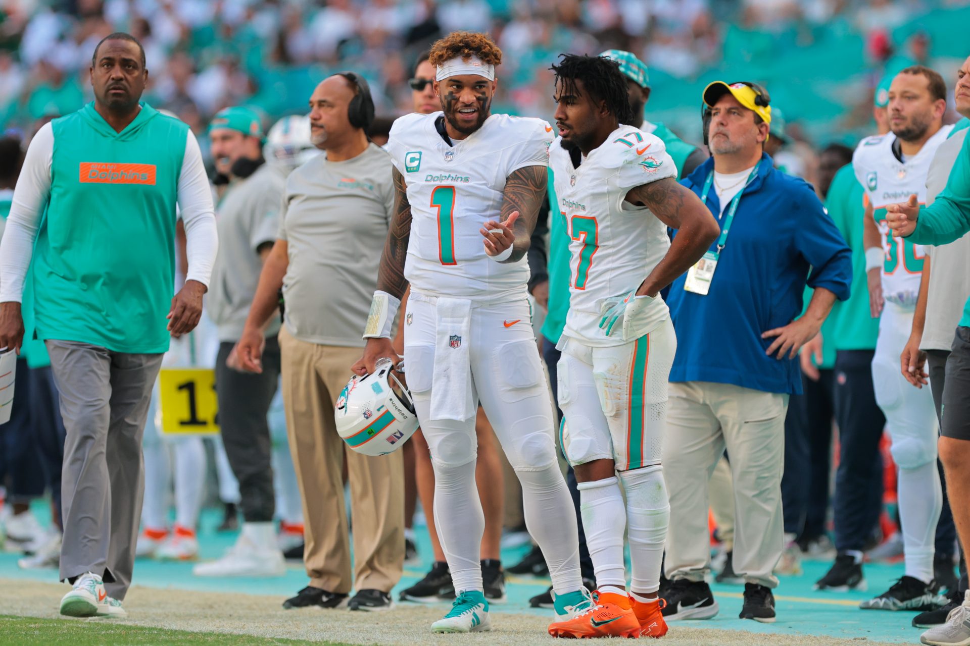 Miami Dolphins quarterback Tua Tagovailoa (1) talks to wide receiver Jaylen Waddle (17) on the sideline against the New England Patriots during the second quarter at Hard Rock Stadium.