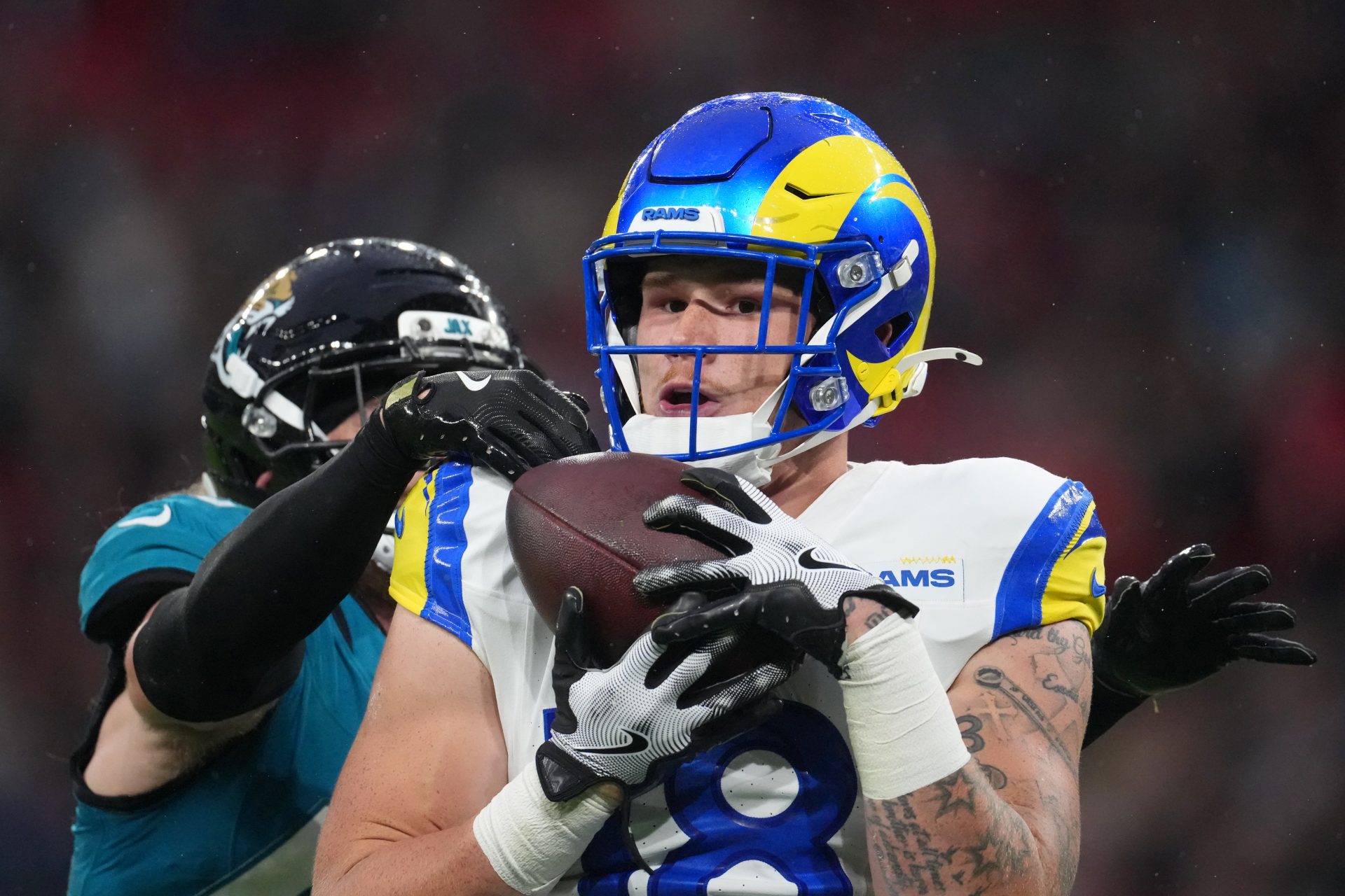 Los Angeles Rams tight end Terrance Ferguson (18) makes a catch against Jacksonville Jaguars safety Andrew Wingard (42) during the second half of an NFL International Series game at Wembley Stadium.