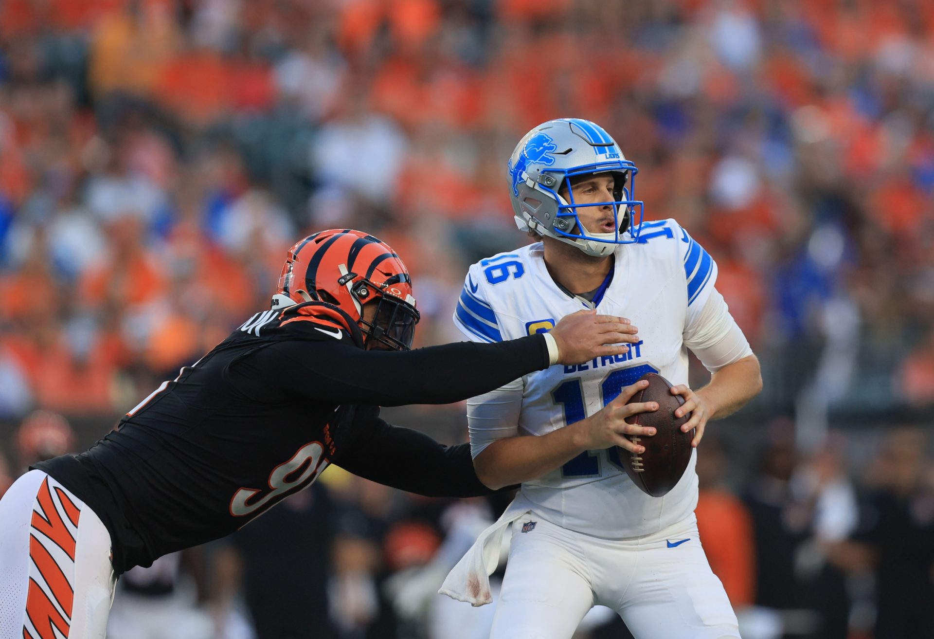 Detroit Lions quarterback Jared Goff (16) is tackled by Cincinnati Bengals defensive end Trey Hendrickson (91) during the fourth quarter at Paycor Stadium.