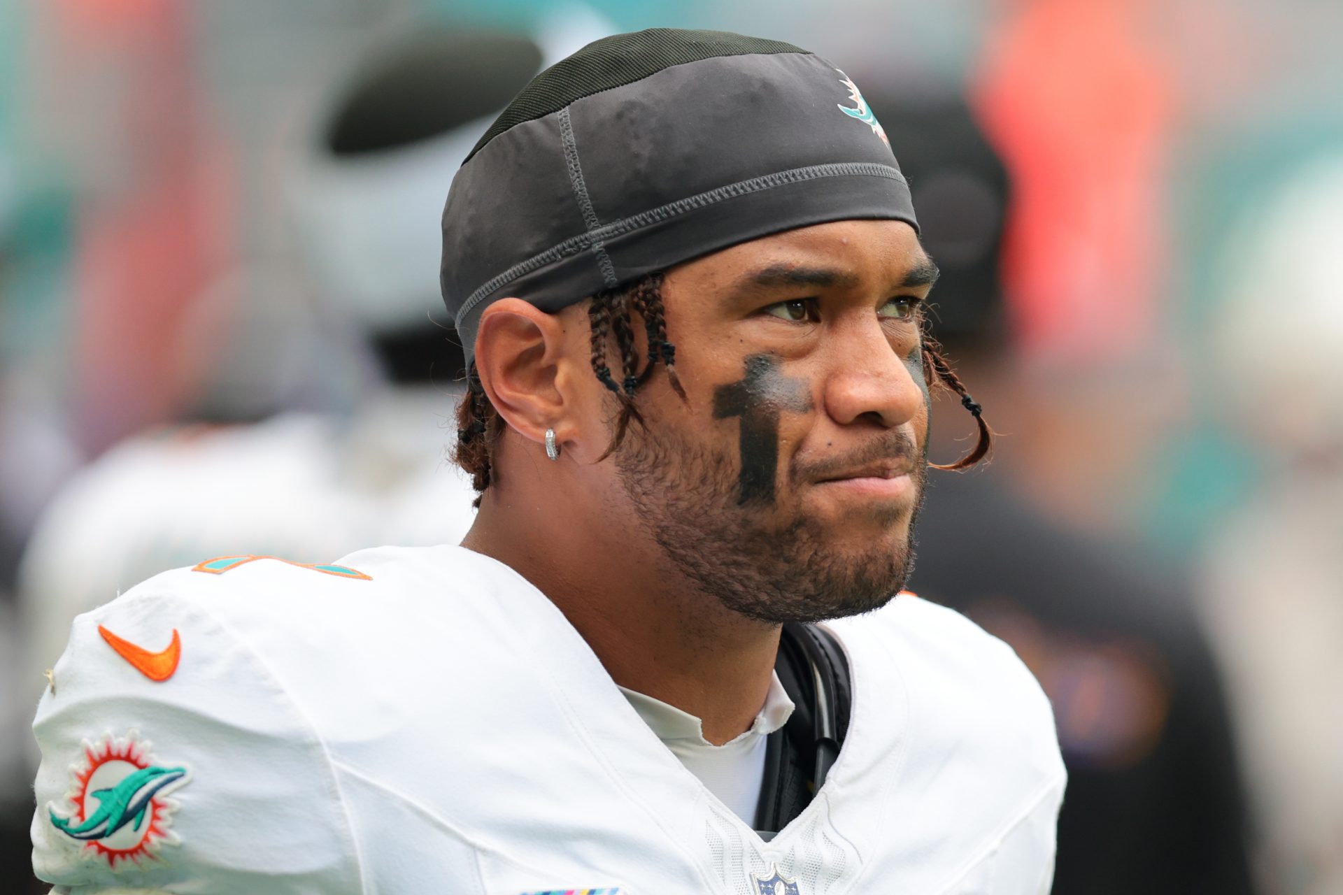 Miami Dolphins quarterback Tua Tagovailoa (1) looks on from thevbench against the Los Angeles Chargers during the fourth quarter at Hard Rock Stadium.