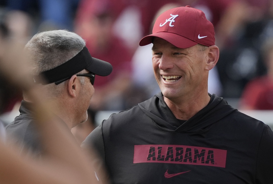 Eastern Illinois head coach Chris Wilkerson and Alabama head coach Kalen DeBoer talk before the game at Saban Field at Bryant-Denny Stadium.