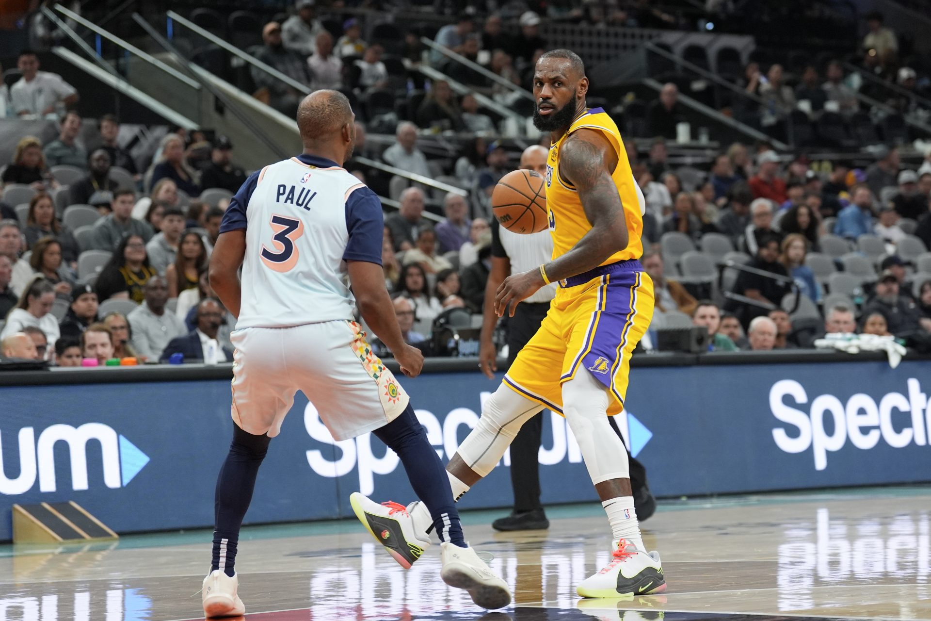 Los Angeles Lakers forward LeBron James (23) controls the ball in front of San Antonio Spurs guard Chris Paul (3) in the second half at Frost Bank Center.