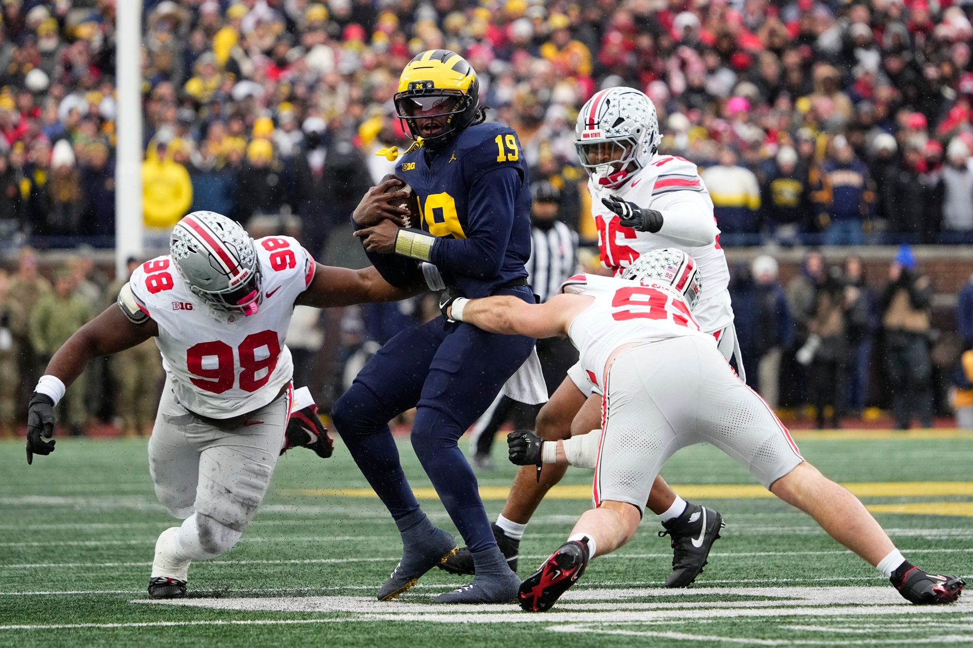 Ohio State Buckeyes defensive end Caden Curry (92) abd defensive tackle Kayden McDonald (98) hit Michigan Wolverines quarterback Bryce Underwood (19) during the NCAA football game at Michigan Stadium in Ann Arbor, Mich. on Nov. 29, 2025.