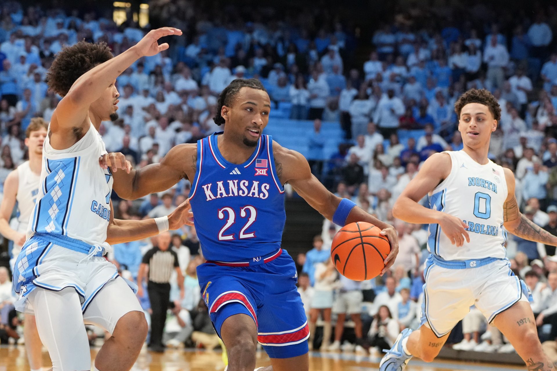 Kansas Jayhawks guard Darryn Peterson (22) with the ball as North Carolina Tar Heels guard Seth Trimble (7) and guard Kyan Evans (0) defend in the first half at Dean E. Smith Center.