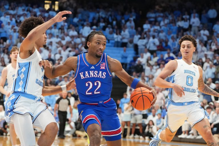 Kansas Jayhawks guard Darryn Peterson (22) with the ball as North Carolina Tar Heels guard Seth Trimble (7) and guard Kyan Evans (0) defend in the first half at Dean E. Smith Center.