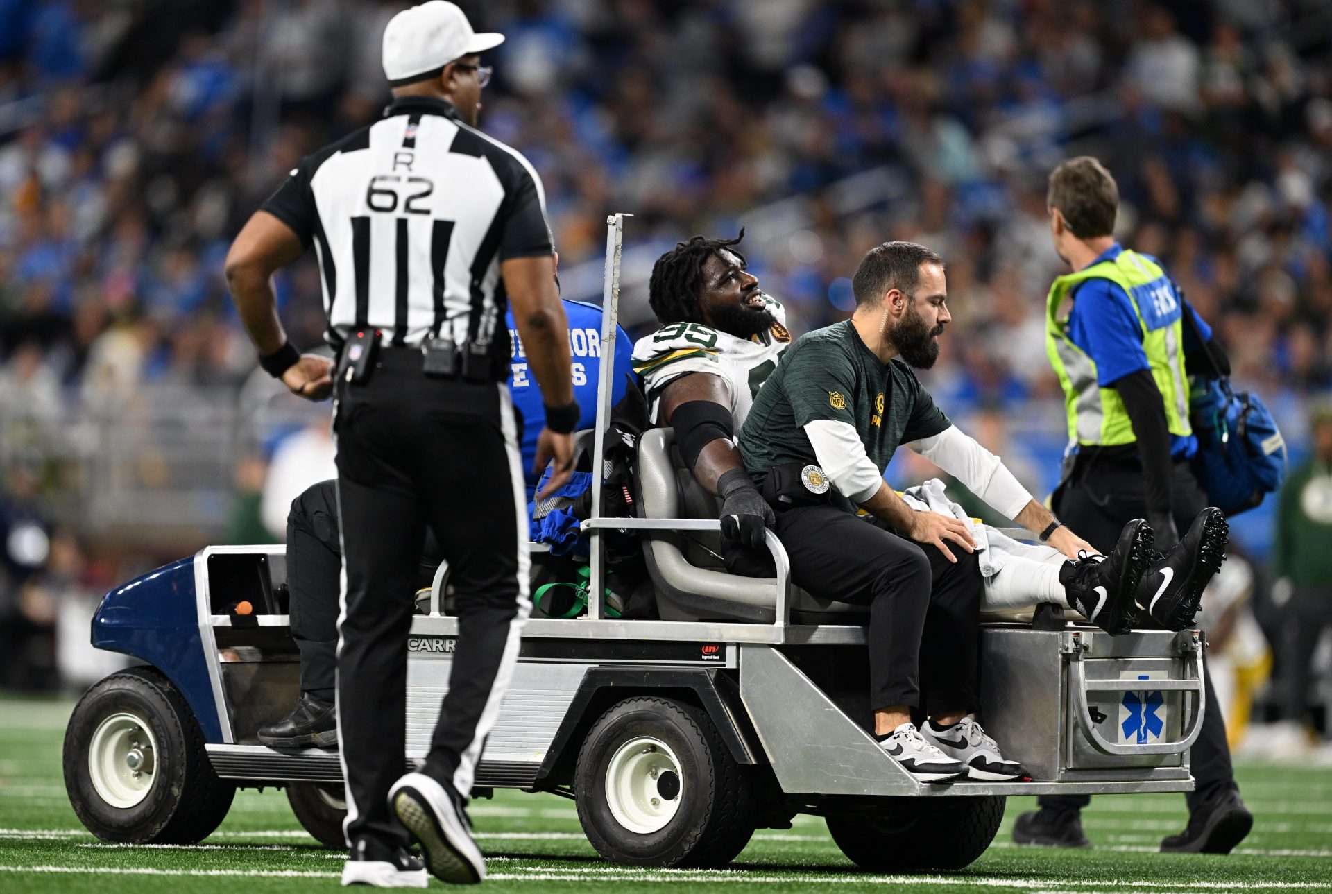 Green Bay Packers defensive tackle Devonte Wyatt (95) is carted off the field after an injury against the Detroit Lions during the third quarter at Ford Field.